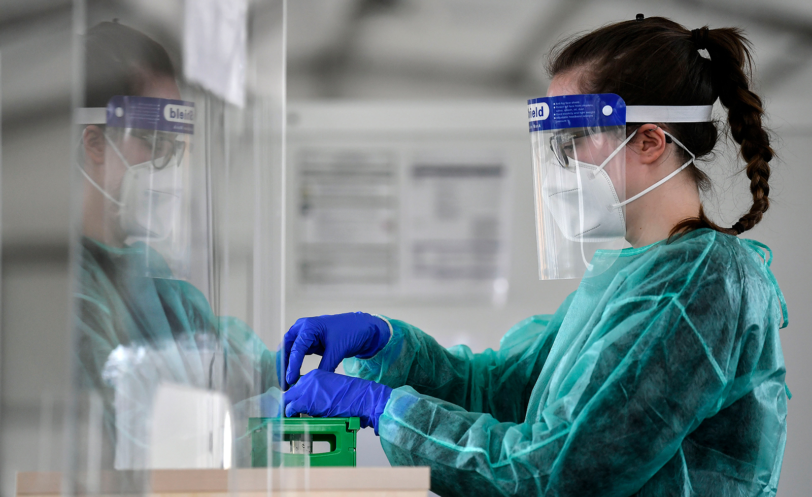 Medical staff prepares samples from students at a new built COVID-19 test center for the beginning of the new semester at the university in Dortmund, Germany, on April 12.