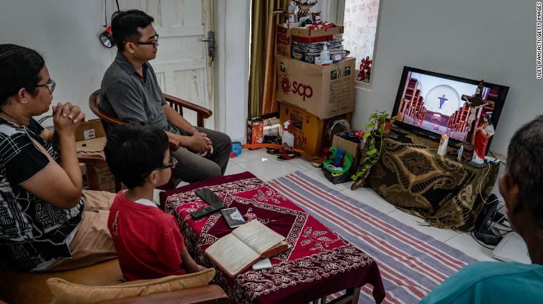 A family listens to a prayer through live internet streaming on April 10 in Yogyakarta, Indonesia.