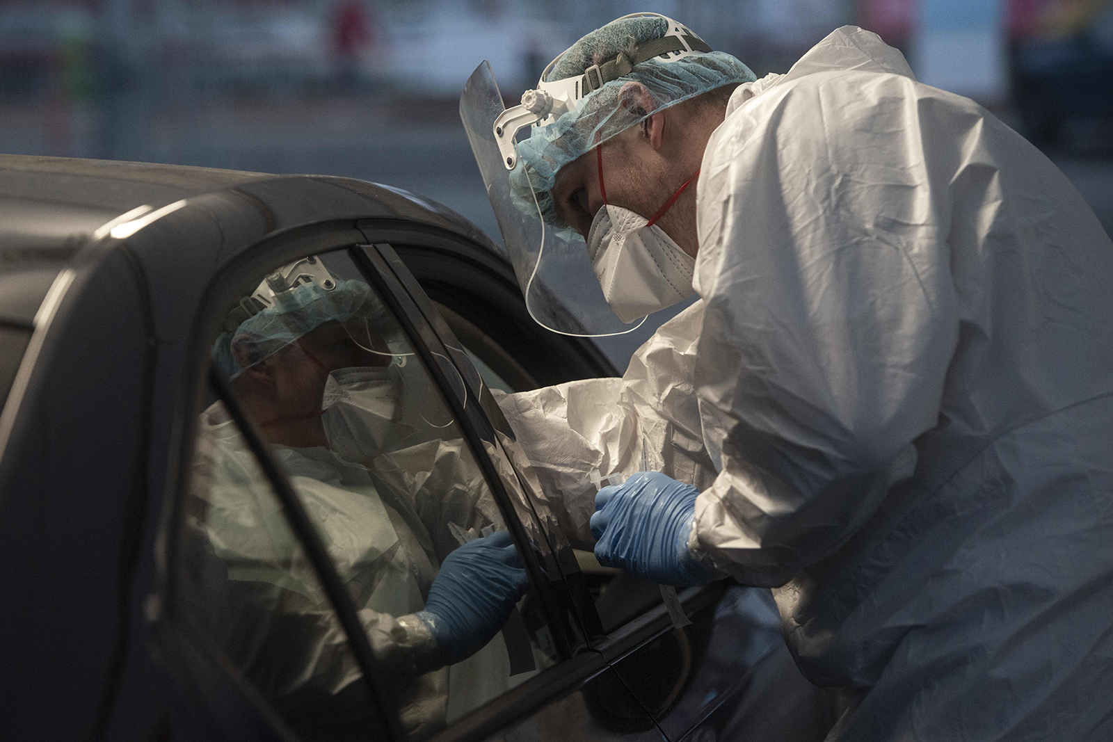 A medical worker wearing protective equipment takes a sample at a drive-in Covid-19 testing station in Prague, Czech Republic, on February 23.