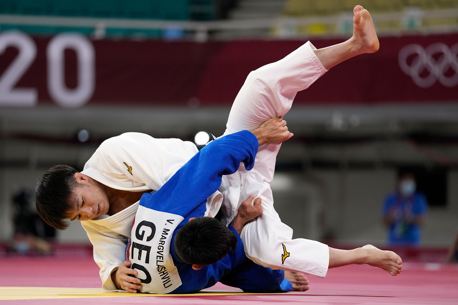 Hifumi Abe of Japan, top, and Vazha Margvelashvili of Georgia compete during their judo match on Sunday, July 25. 