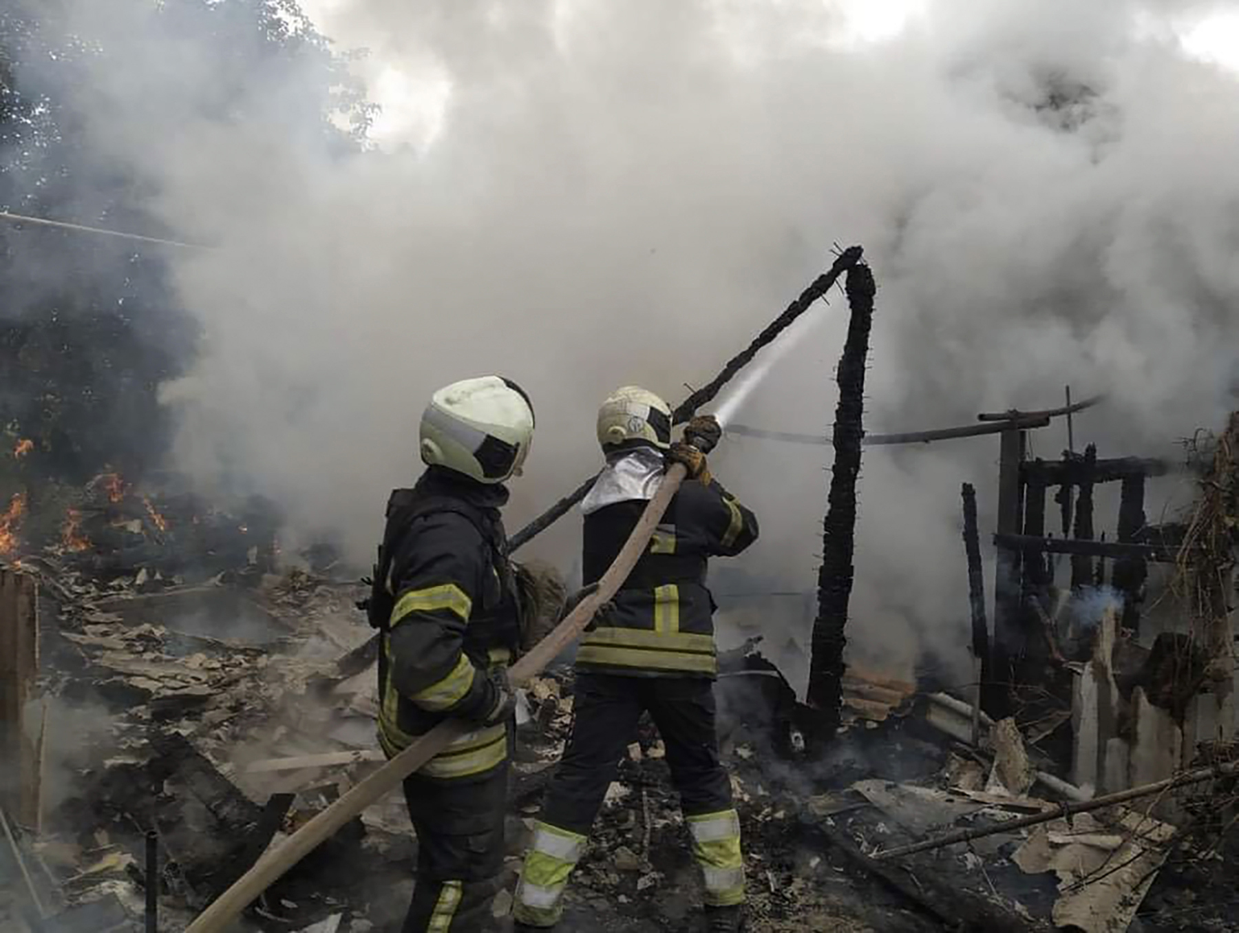 Ukrainian firefighters work to extinguish a fire at a damaged residential building in Lysychansk, on Sunday.