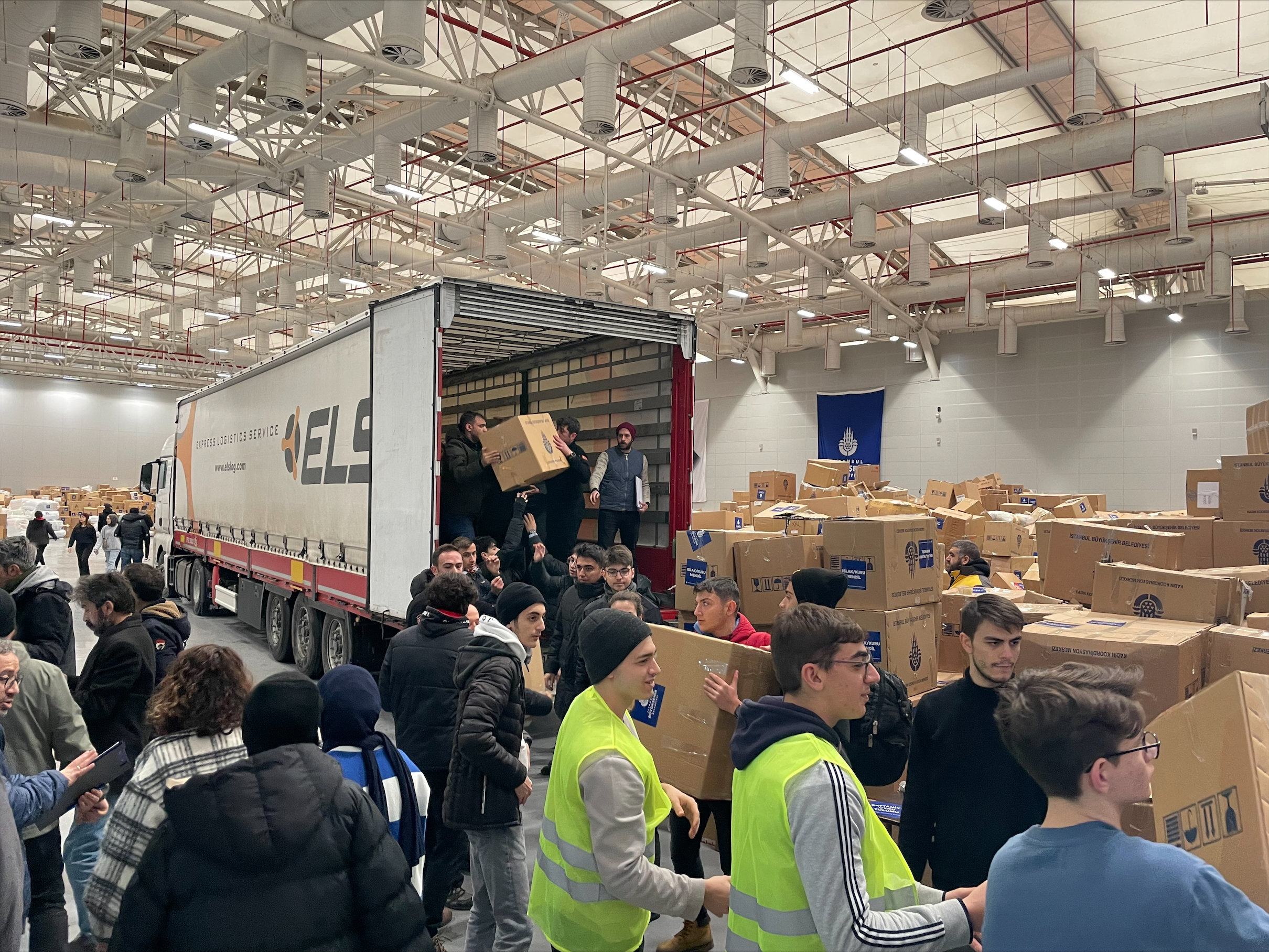 Volunteers and city council workers prepare donated goods to be driven 12 hours from the Topbaş Performance and Art Center in Istanbul to the disaster-hit areas. 