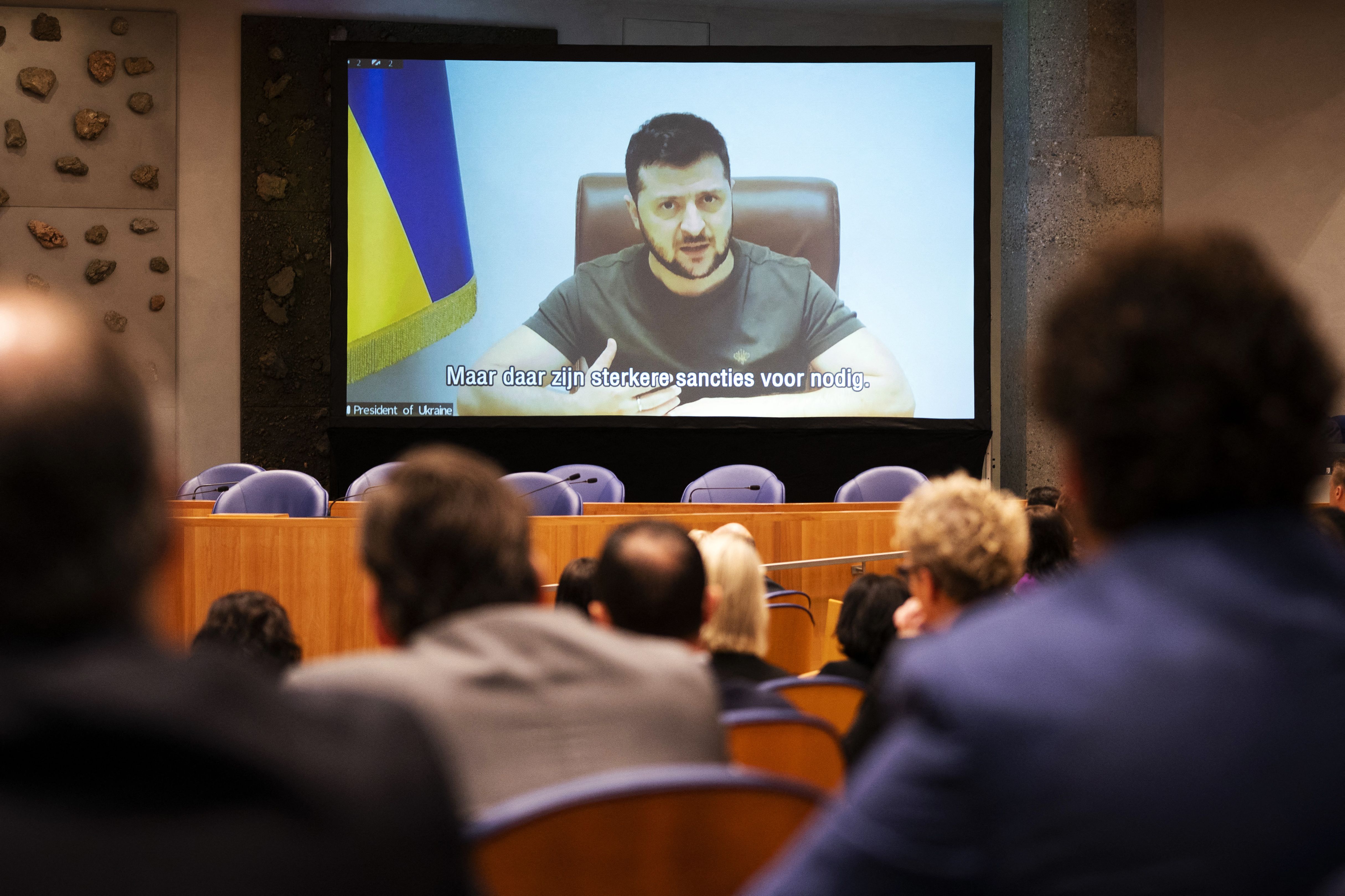 Ukrainian President Volodymyr Zelensky (on screen) addresses the Dutch House of Representatives in The Hague on March 31, in hopes of getting support in response to Russia's invasion of Ukraine. 