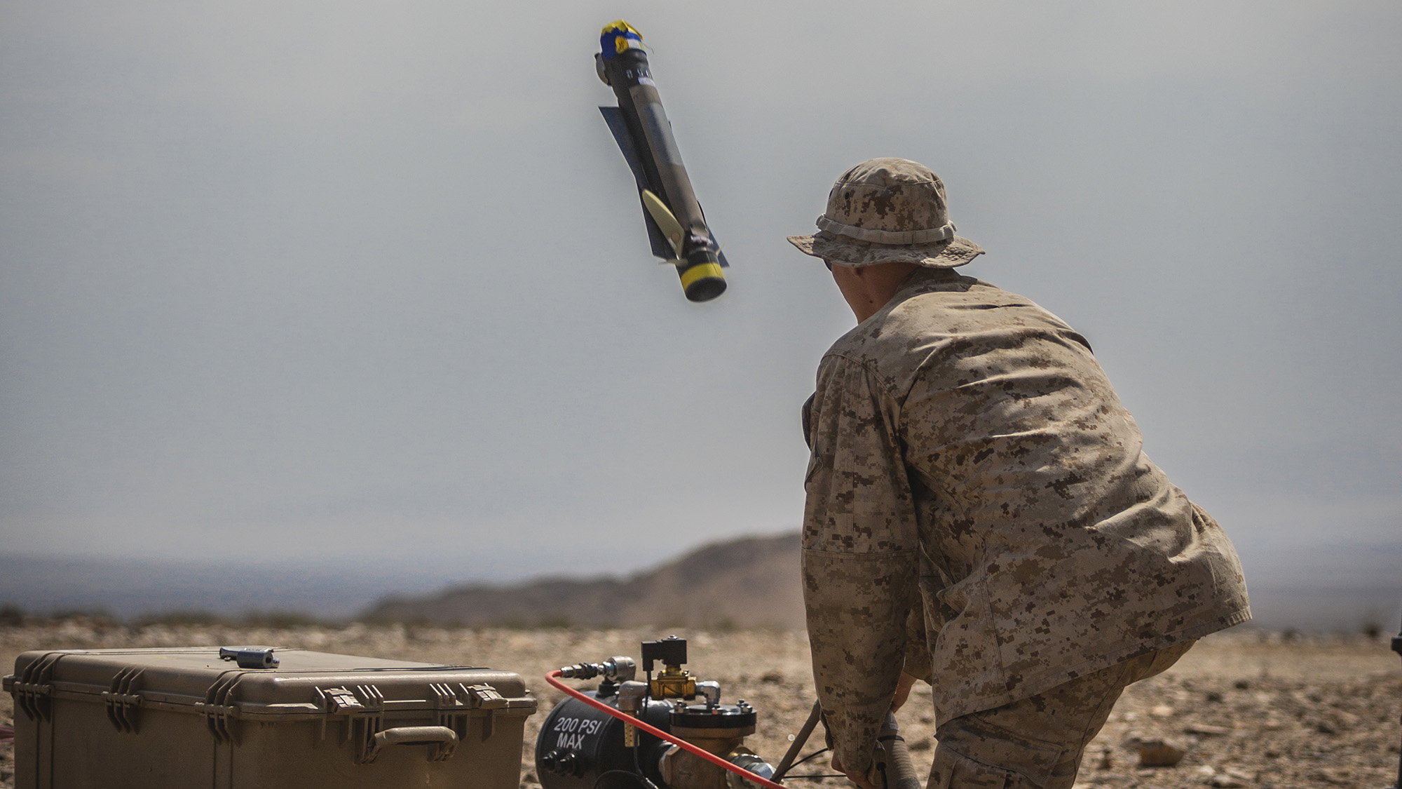 A US Marine launches a Switchblade 300 10C system during a training exercise at the Marine Corps Air Ground Combat Center Twentynine Palms, California on Sept. 24, 2021. 