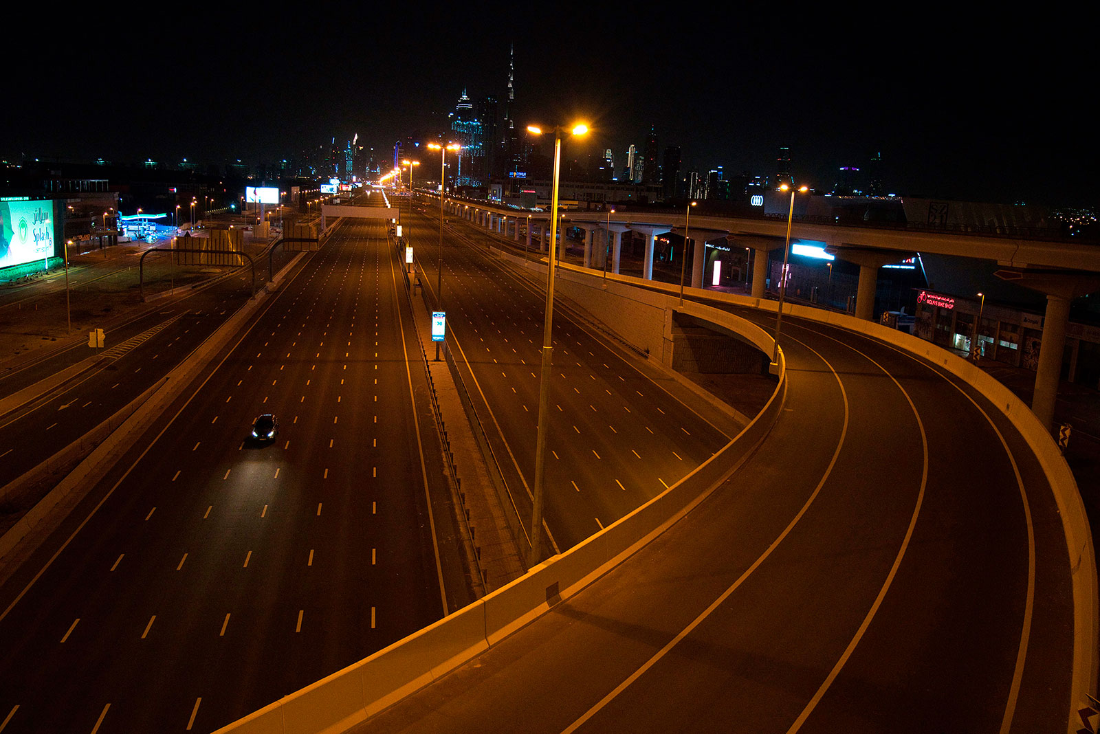 A car travels down nearly empty road in Dubai on Tuesday, March 31.