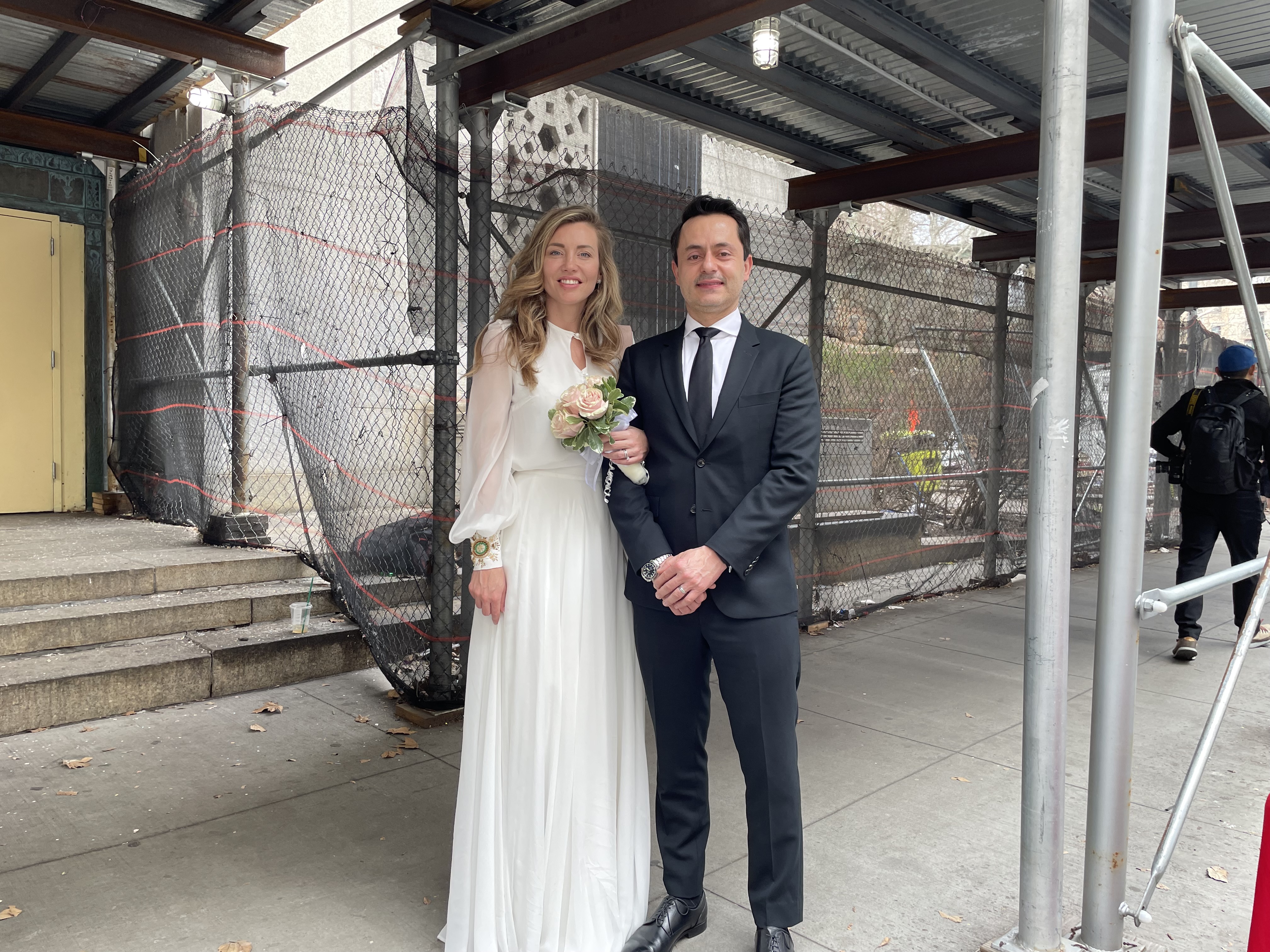 Newlyweds Carlos Giraldo and Galina Rusnak got married around the corner from where former President Donald Trump's arraignment took place in Lower Manhattan.