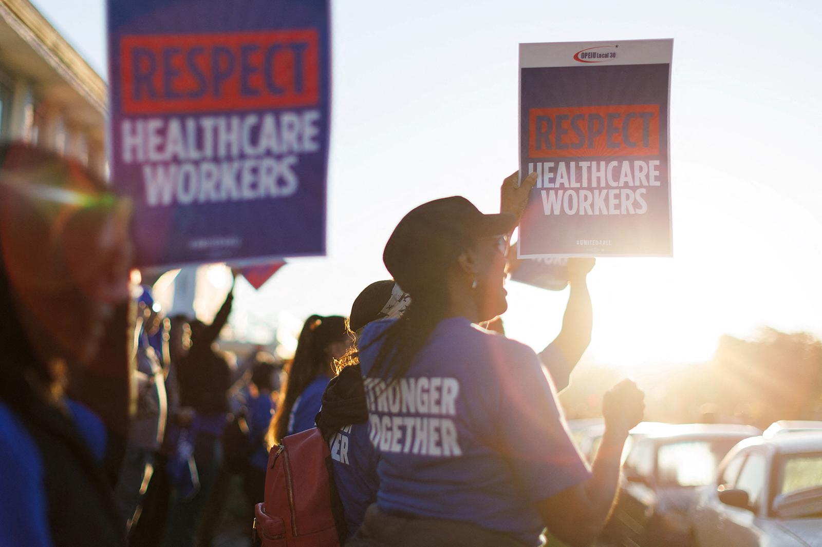 A coalition of Kaiser Permanente Unions representing 75,000 healthcare workers started a three day strike across the United States over a new contract. People are seen holding placards in San Diego, California, on October 4.