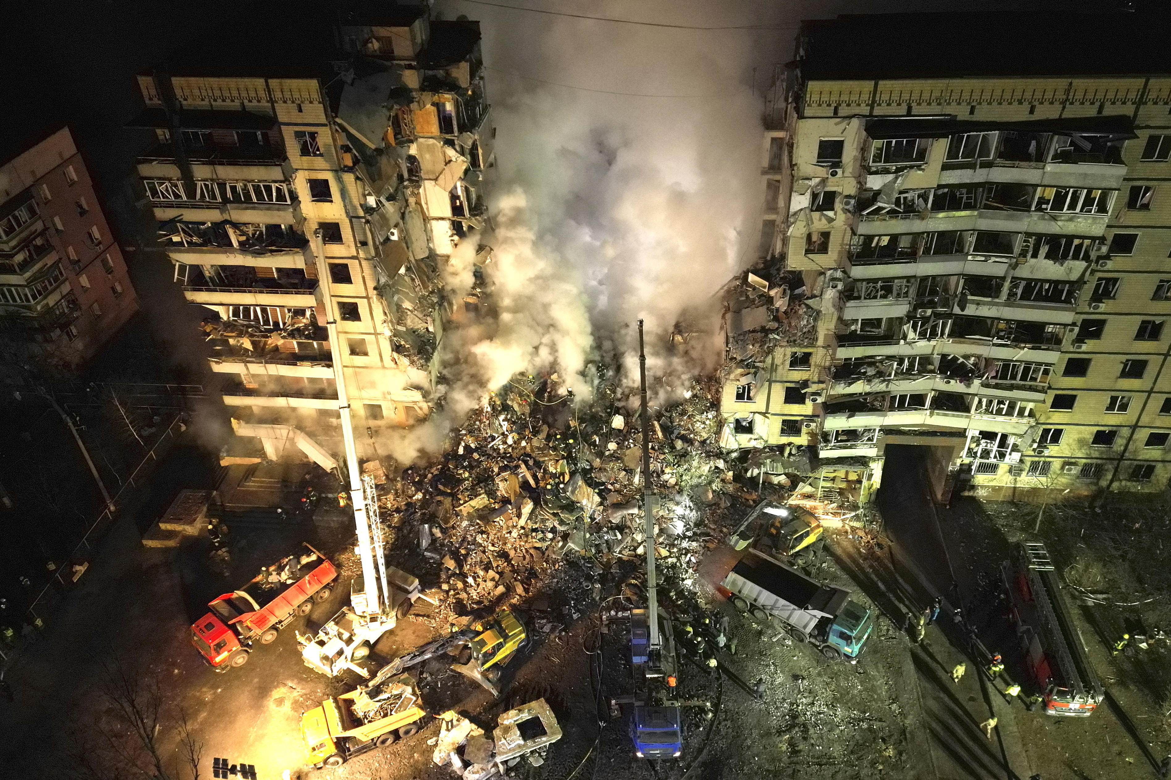Emergency workers clear the rubble after a Russian missile hit an apartment block in Dnipro, on Saturday.
