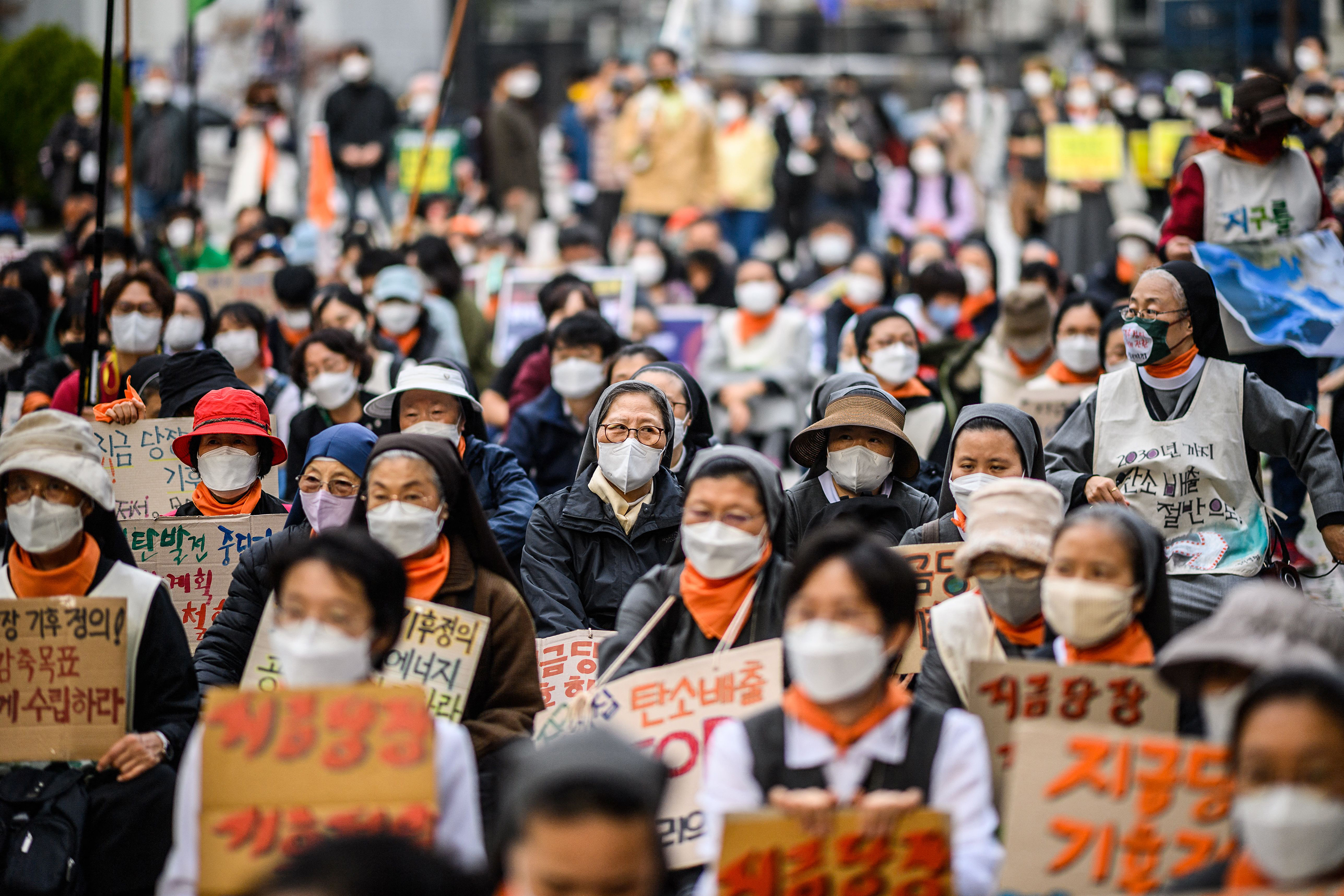 People participate in a rally during a global day of action on climate change in Seoul, South Korea, on November 6. 