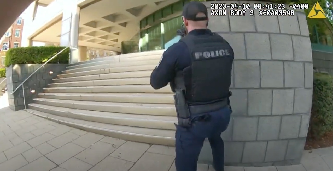 Body camera footage from LMPD Officer Nickolas Wilt shows Officer Cory "C.J." Galloway heading up stairs towards the bank.