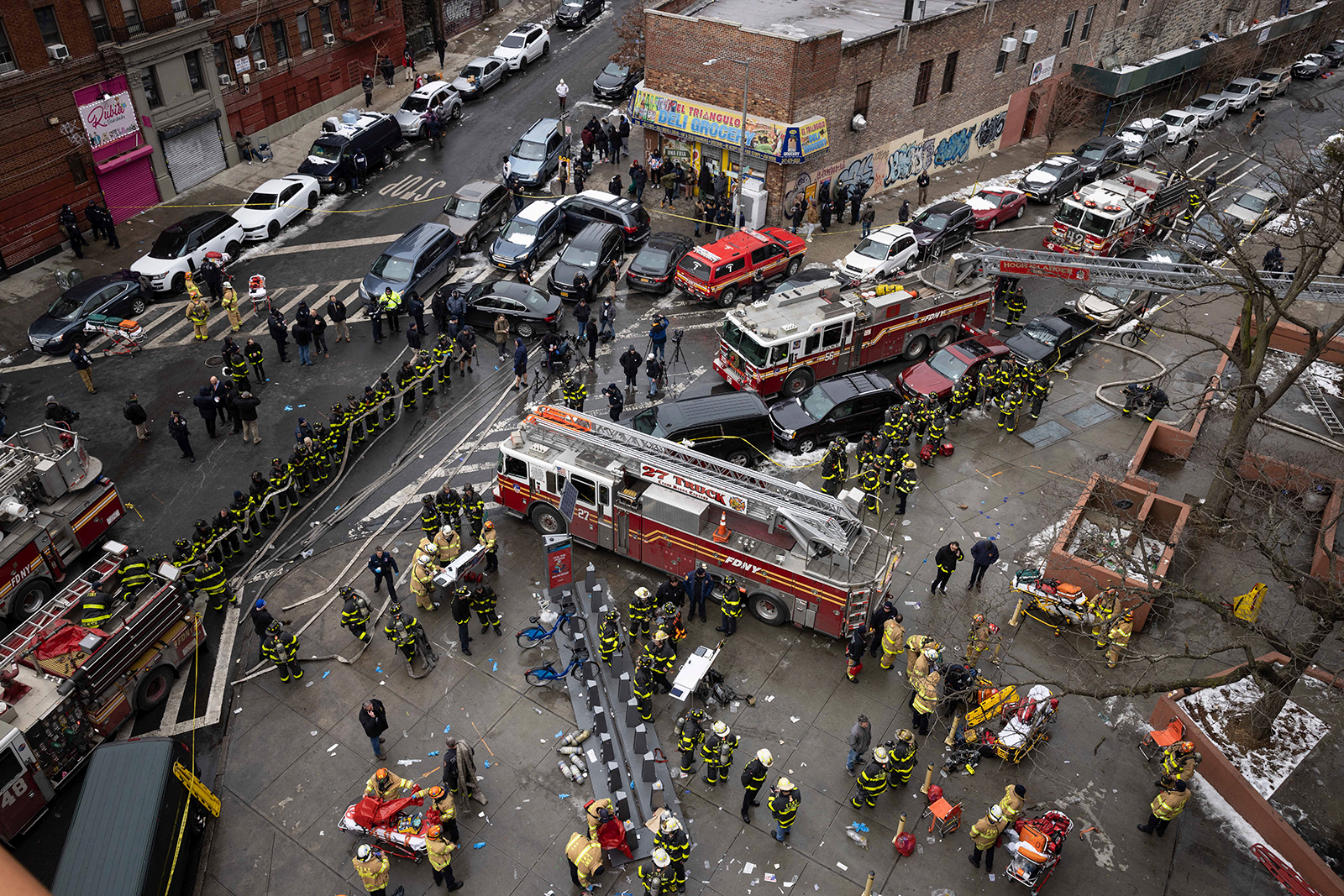 Firefighters work outside an apartment building after a fire in the Bronx, on January 9 in New York. (Yuki Iwamura/AP)
