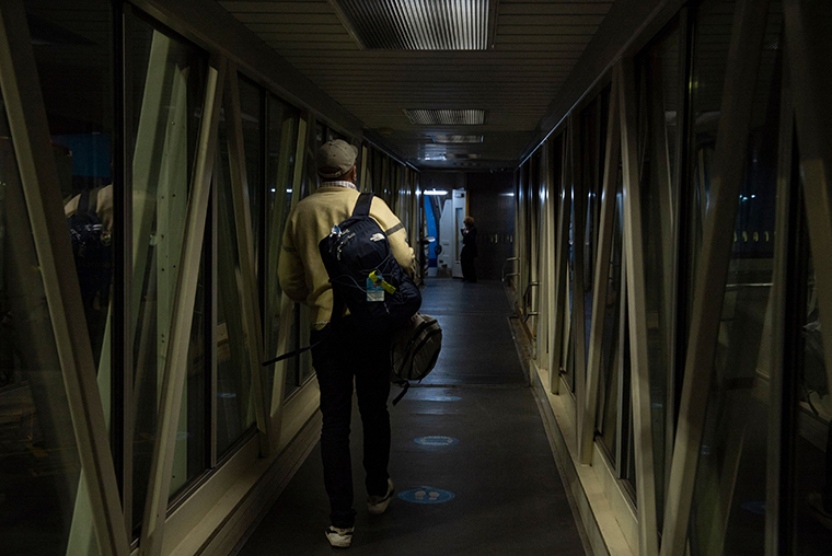 A passenger walks towards the plane while boarding a flight at the OR Tambo International Airport in Johannesburg on November 28, 2021.