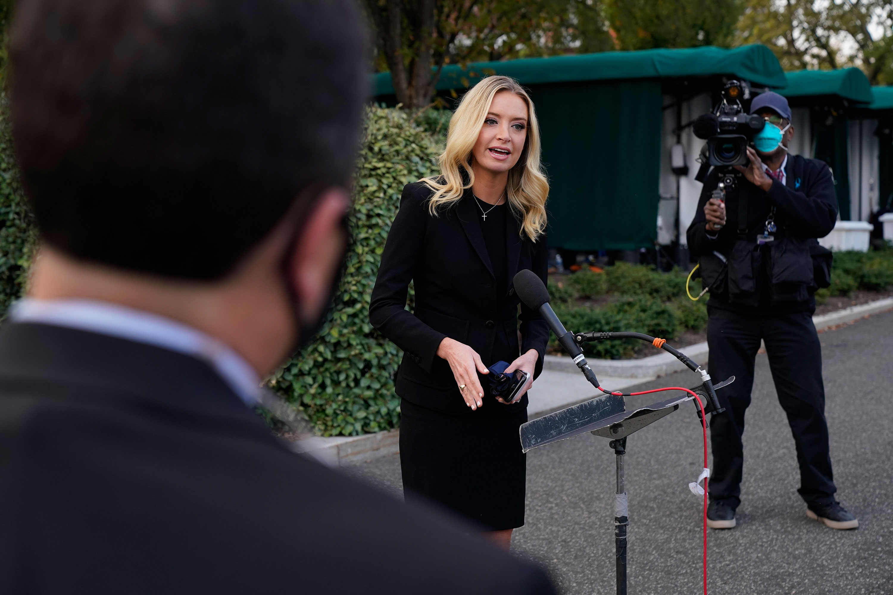 White House press secretary Kayleigh McEnany speaks with reporters outside the White House on October 4 in Washington, DC.