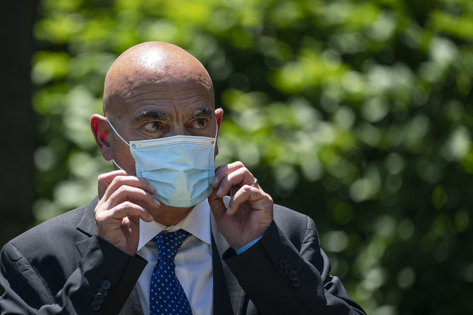Moncef Slaoui, the former head of GlaxoSmithKlines vaccines division, listens as President Donald Trump delivers remarks about coronavirus vaccine development in the Rose Garden of the White House on May 15 in Washington.