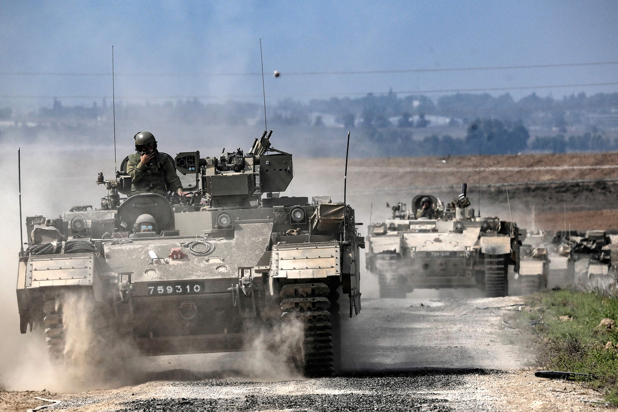 Israeli army Puma armoured personnel carriers (APCs) move in a column near the Gaza border in southern Israel on October 14.