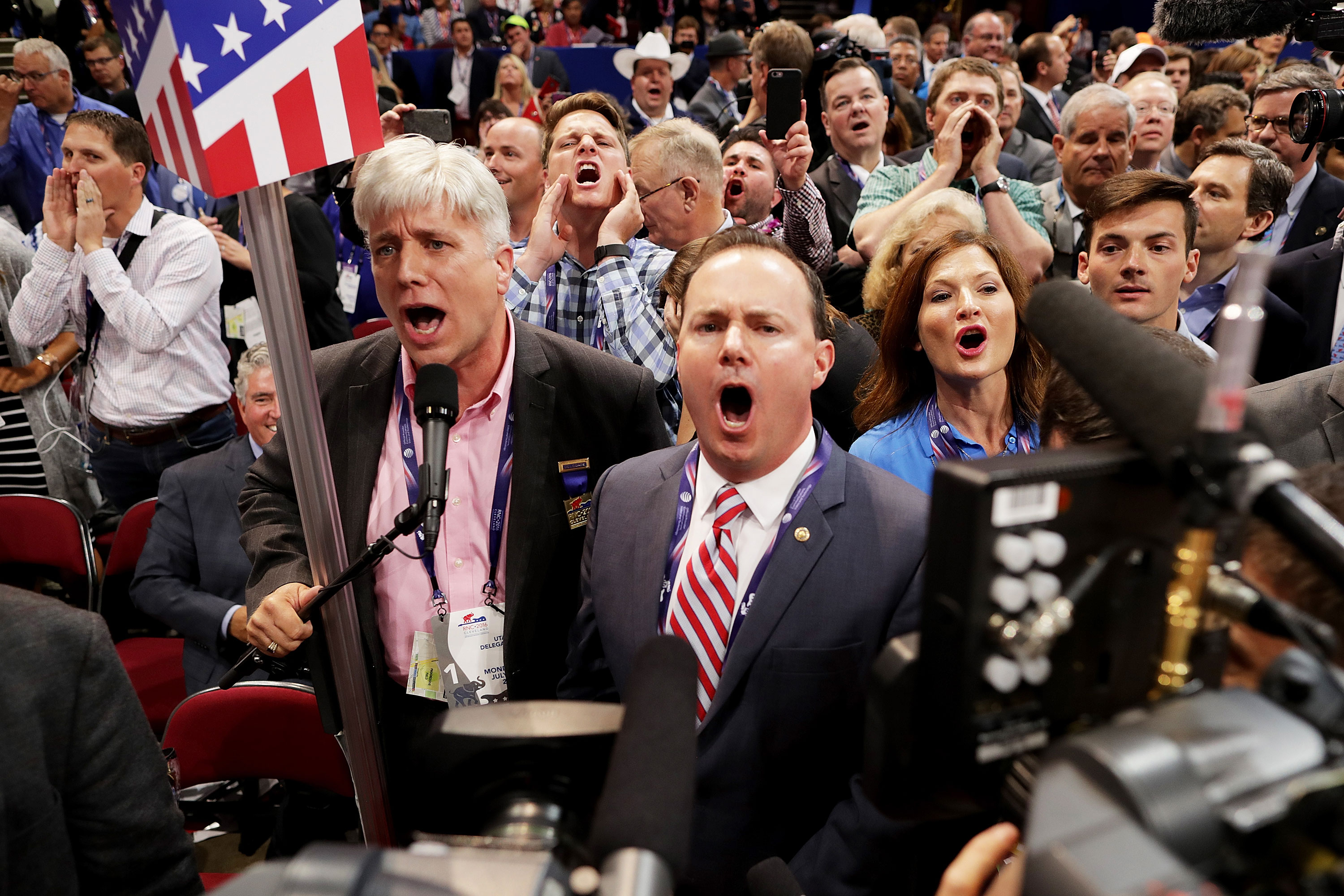 Sen. Mike Lee, center, and others from the Utah State Delegation shout no to the adoption of rules without a roll call vote on the first day of the Republican National Convention in July 2016 in Cleveland, Ohio.