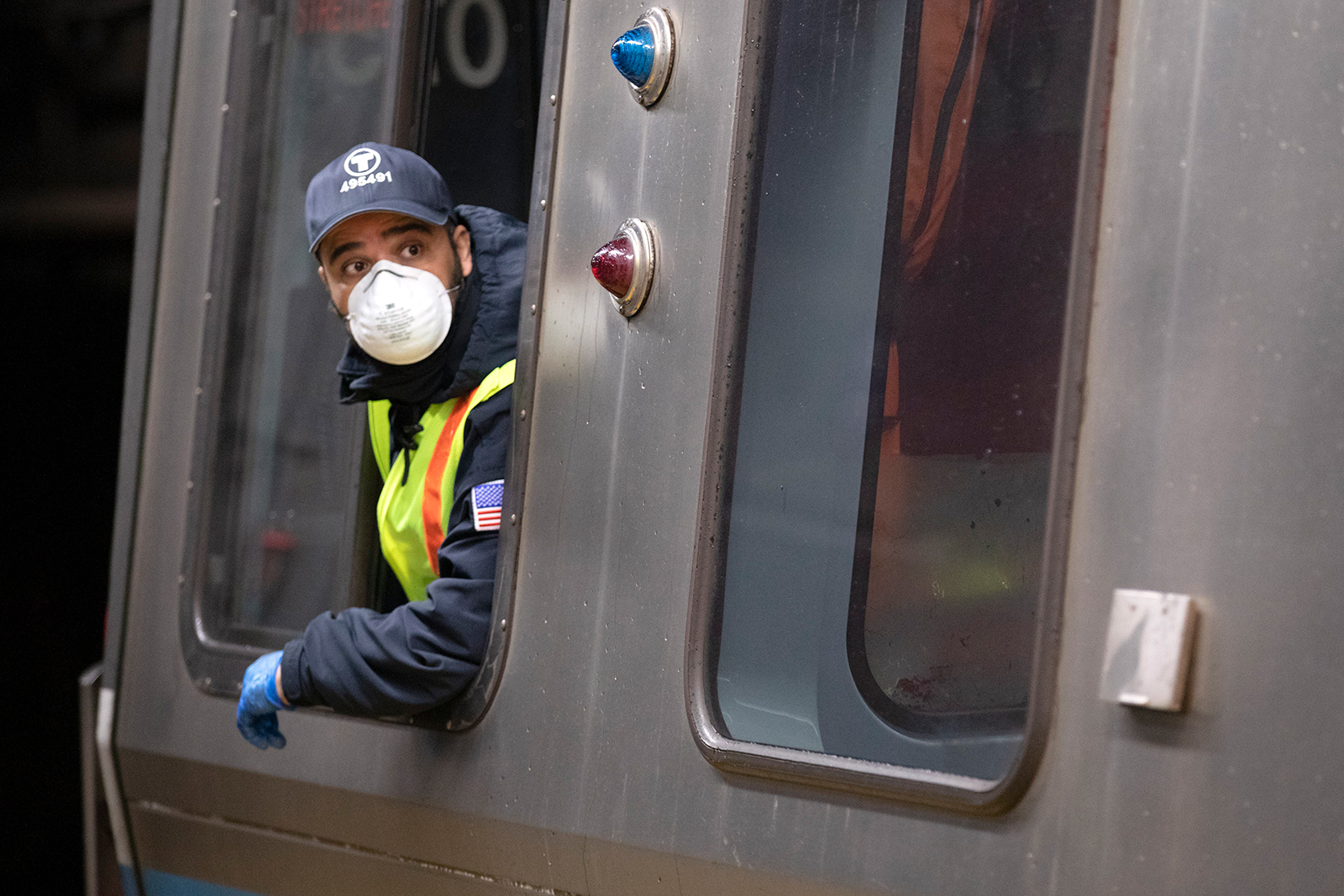 A subway train driver operates the doors at Maverick Station, April 24, in Boston.