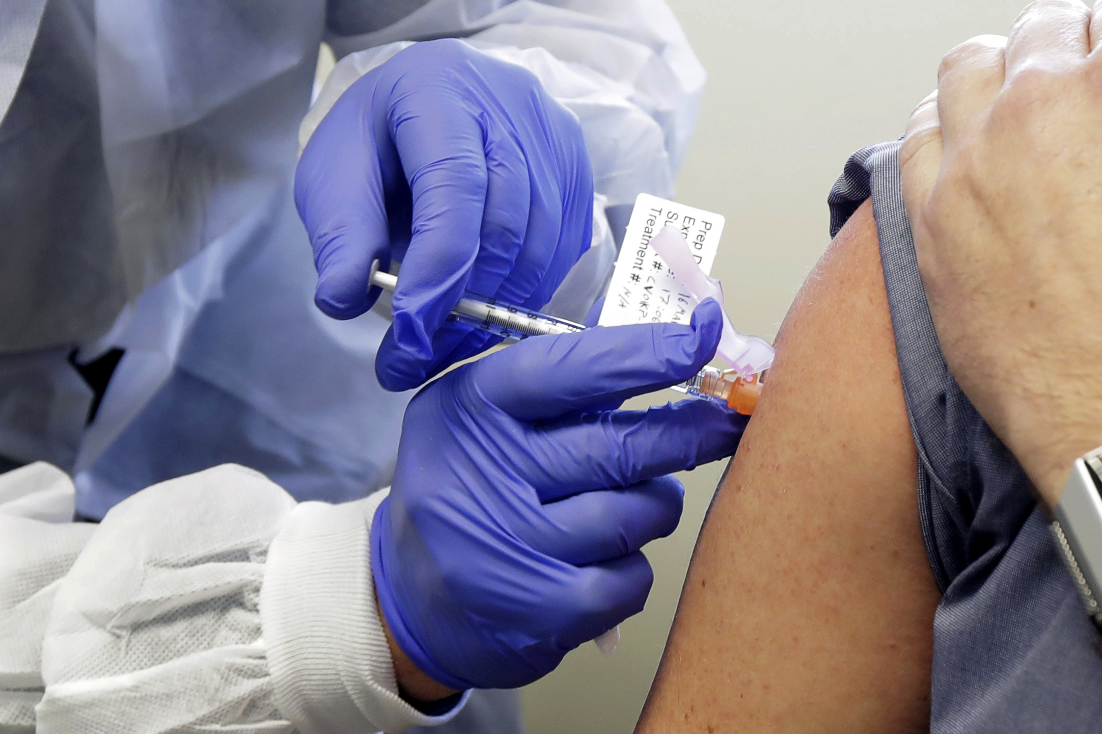 A person in Seattle receives a shot on March 16 in the first-stage clinical trial for a potential Covid-19 vaccine.
