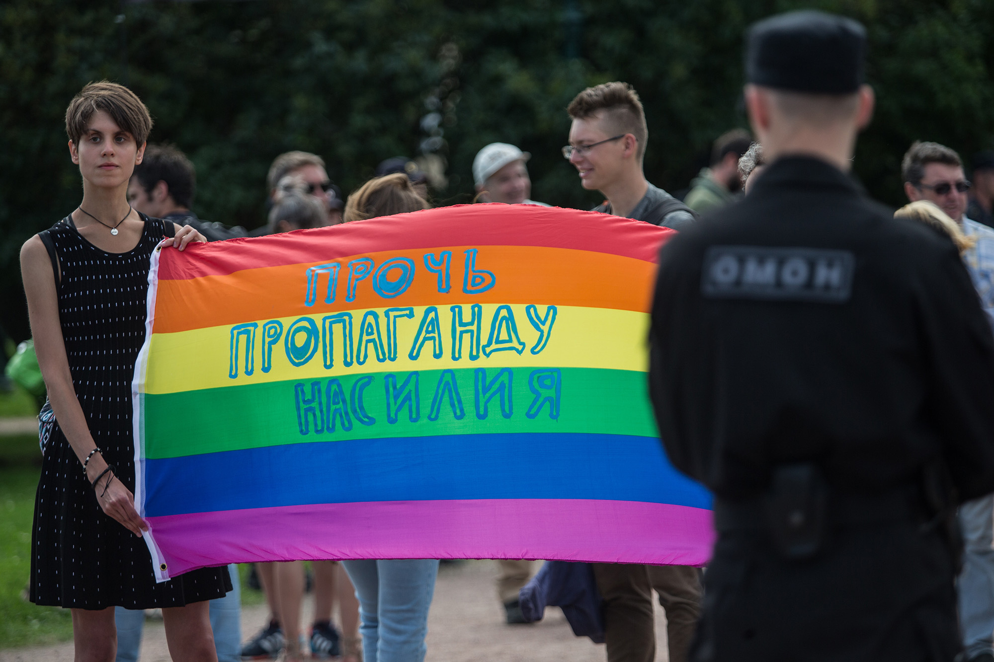 People hold a banner with the inscription 'Stop propaganda of violence' during the Gay Pride demonstration in Field of Mars, St. Petersburg, Russia, on August 12, 2017.