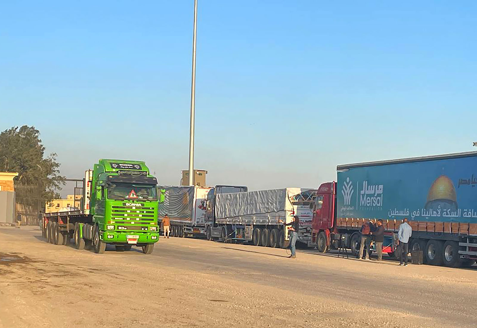 Trucks loaded with humanitarian aid wait for entry into Gaza from the Rafah border crossing in Egypt on Thursday, November 30.
