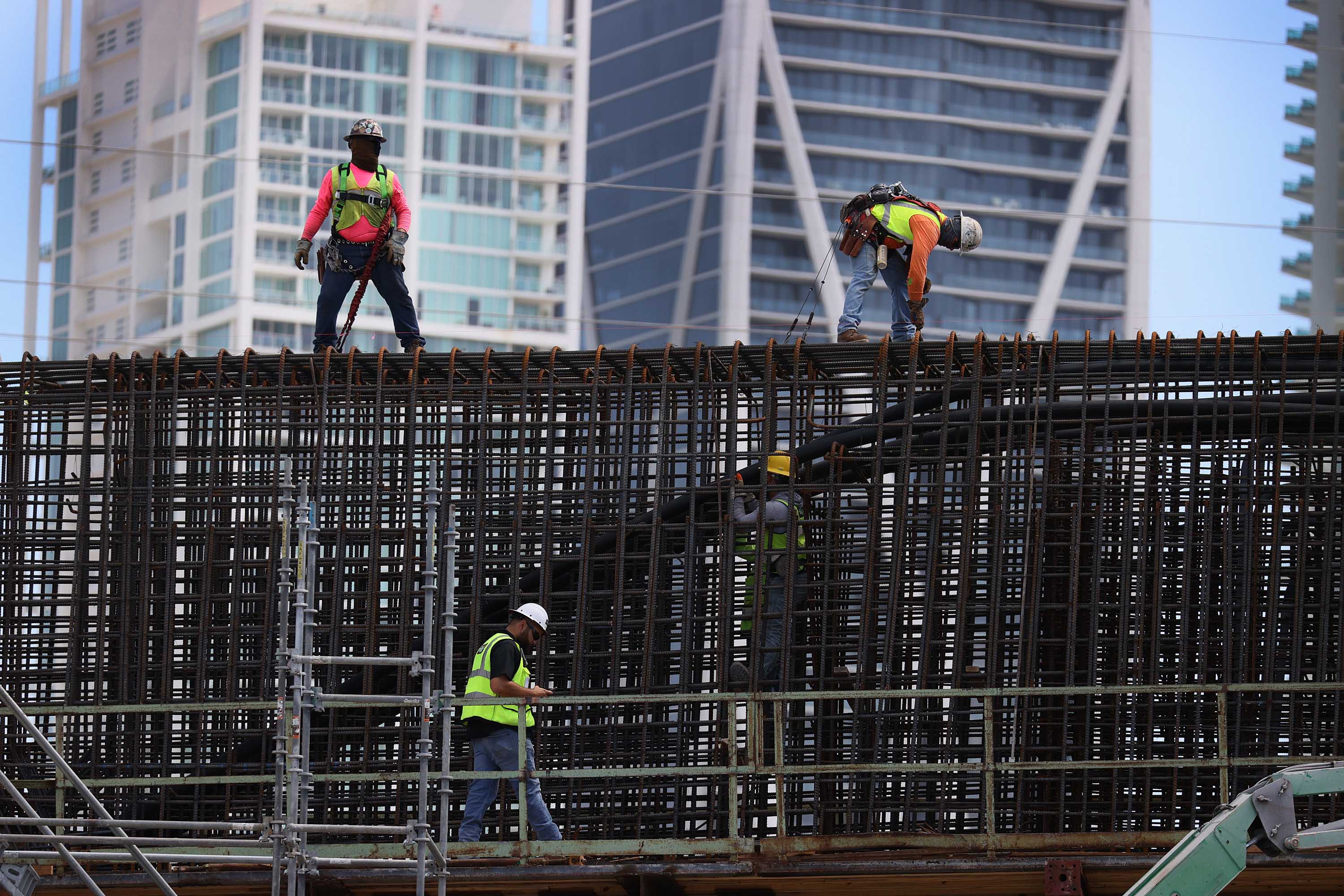 Construction workers build the “Signature Bridge,” on March 17, in Miami, Florida.
