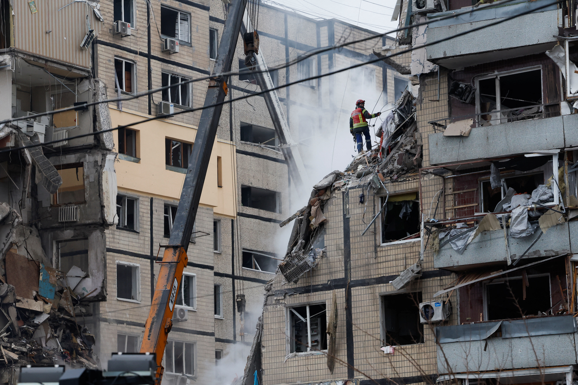 An emergency worker at the site where an apartment block was heavily damaged by a Russian missile strike in Dnipro on Sunday.