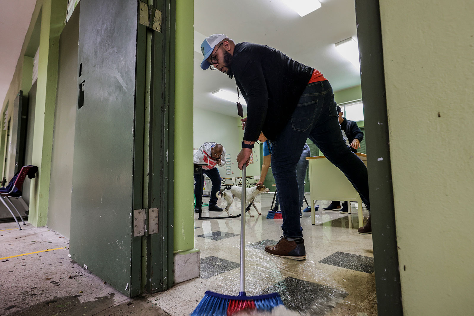 Volunteers remove the water brought by Hurricane Fiona at a storm shelter in Salinas, Puerto Rico on Monday, September 19. 
