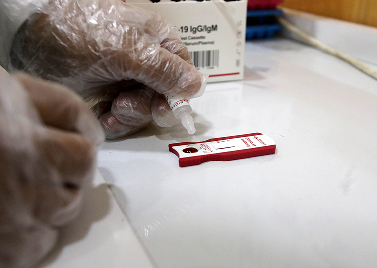A health worker conducts a COVID-19 test with a sample of blood at a health center in Baghdad, Iraq, on August 27.