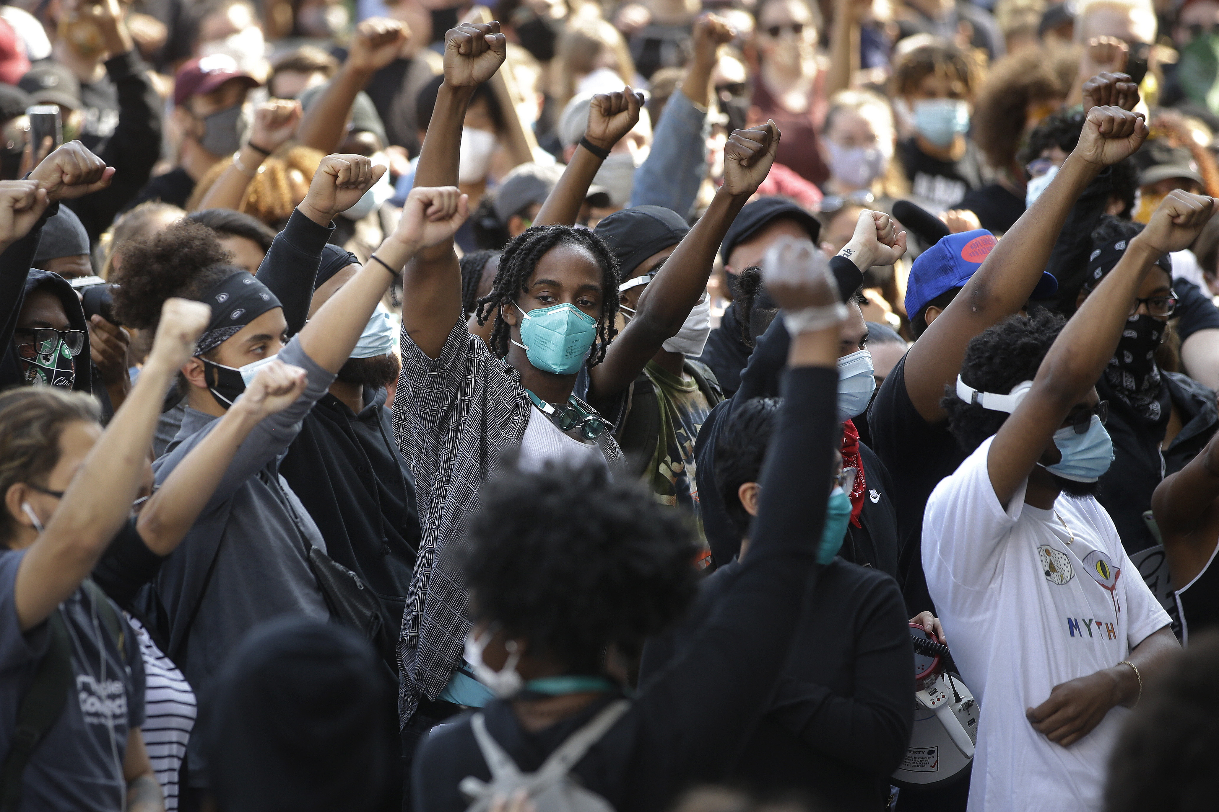 Demonstrators raise their arms during a protest against police brutality on June 10 in Boston.