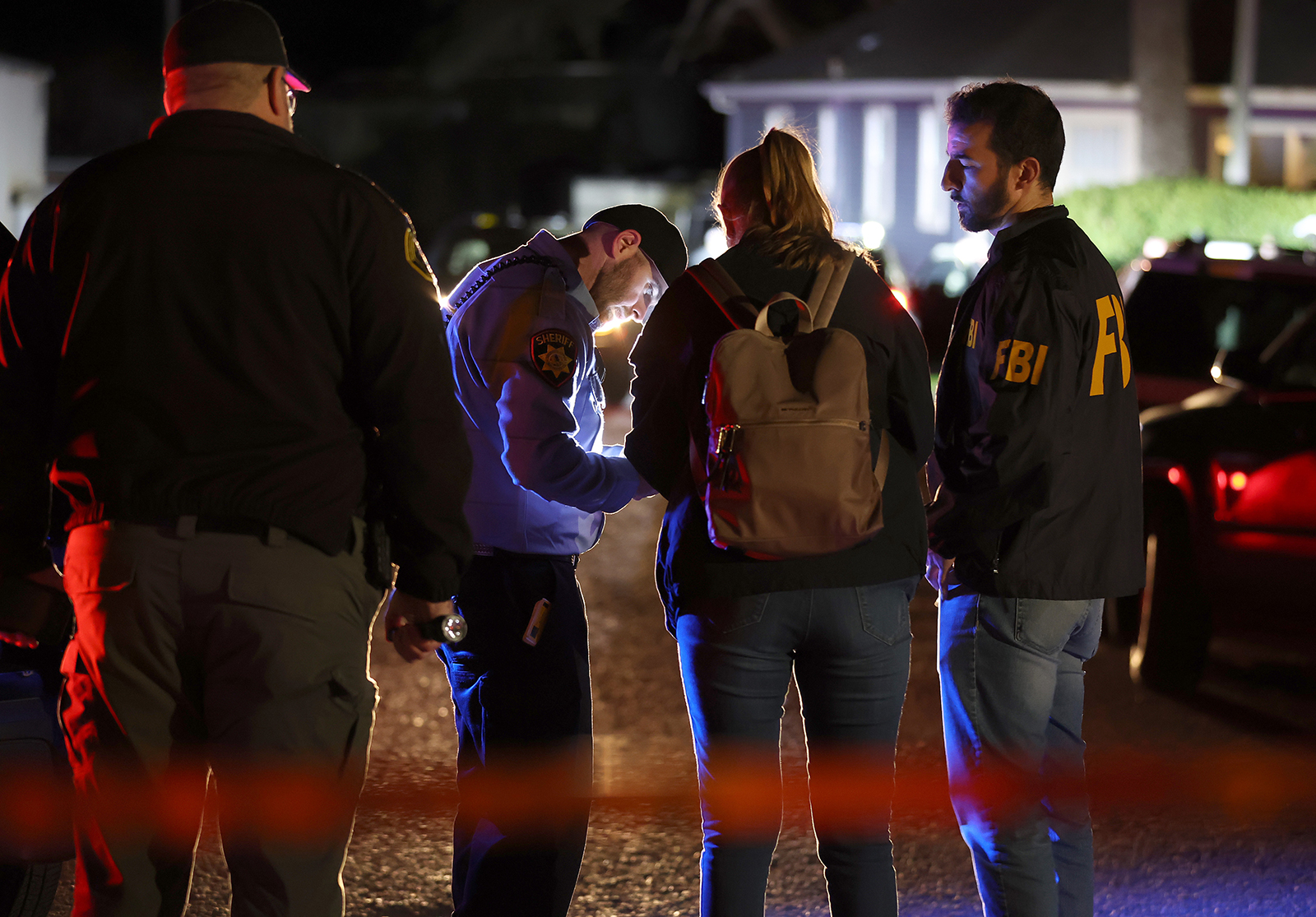 A San Mateo County sheriff deputy checks in FBI agents as they arrive at the scene in Half Moon Bay, California on January 23.
