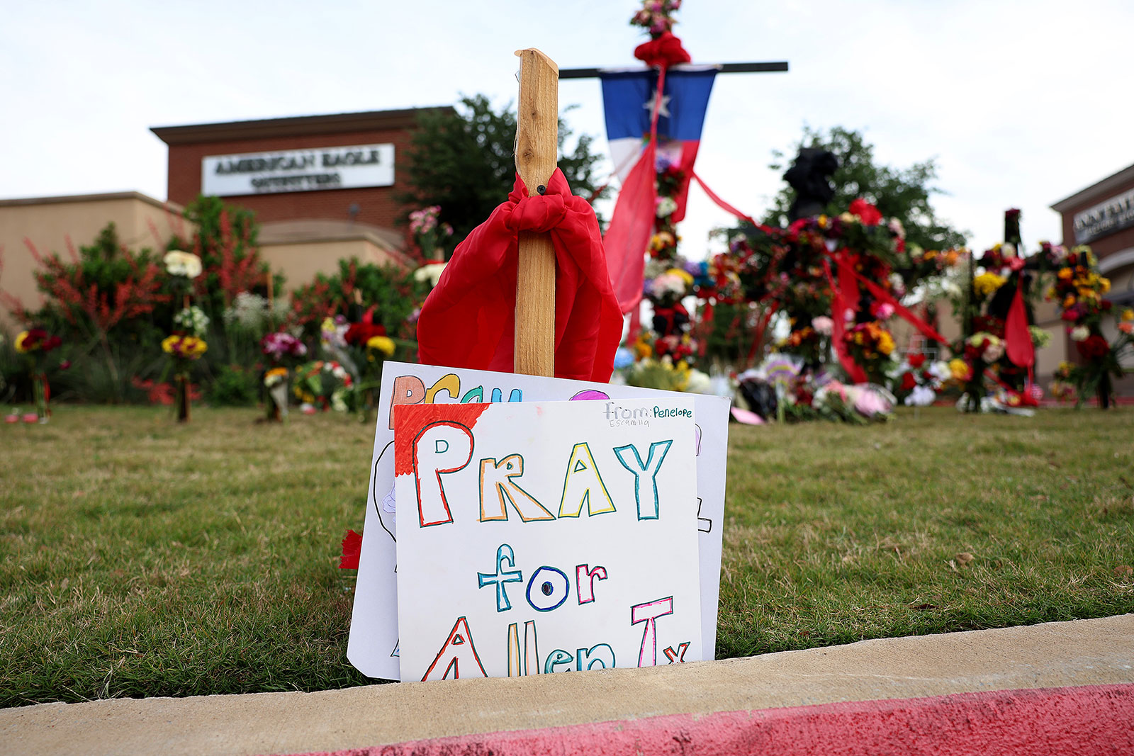 A sign stands at a memorial to those killed at the Allen Premium Outlets mall after the mass shooting occurred on Monday in Allen, Texas. 