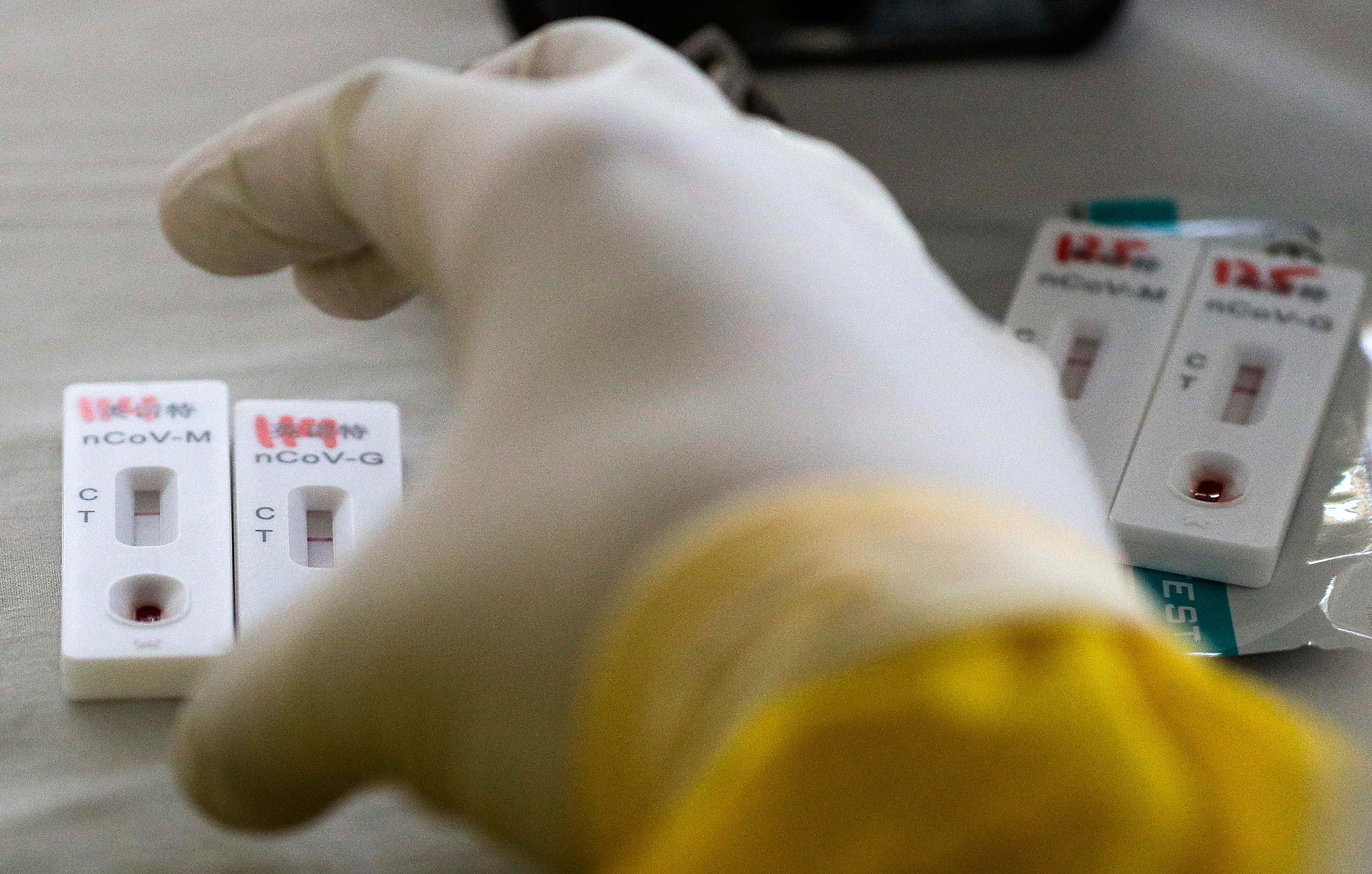 A health worker collects blood samples for mass coronavirus testing in Manila, Philippines, on May 8.