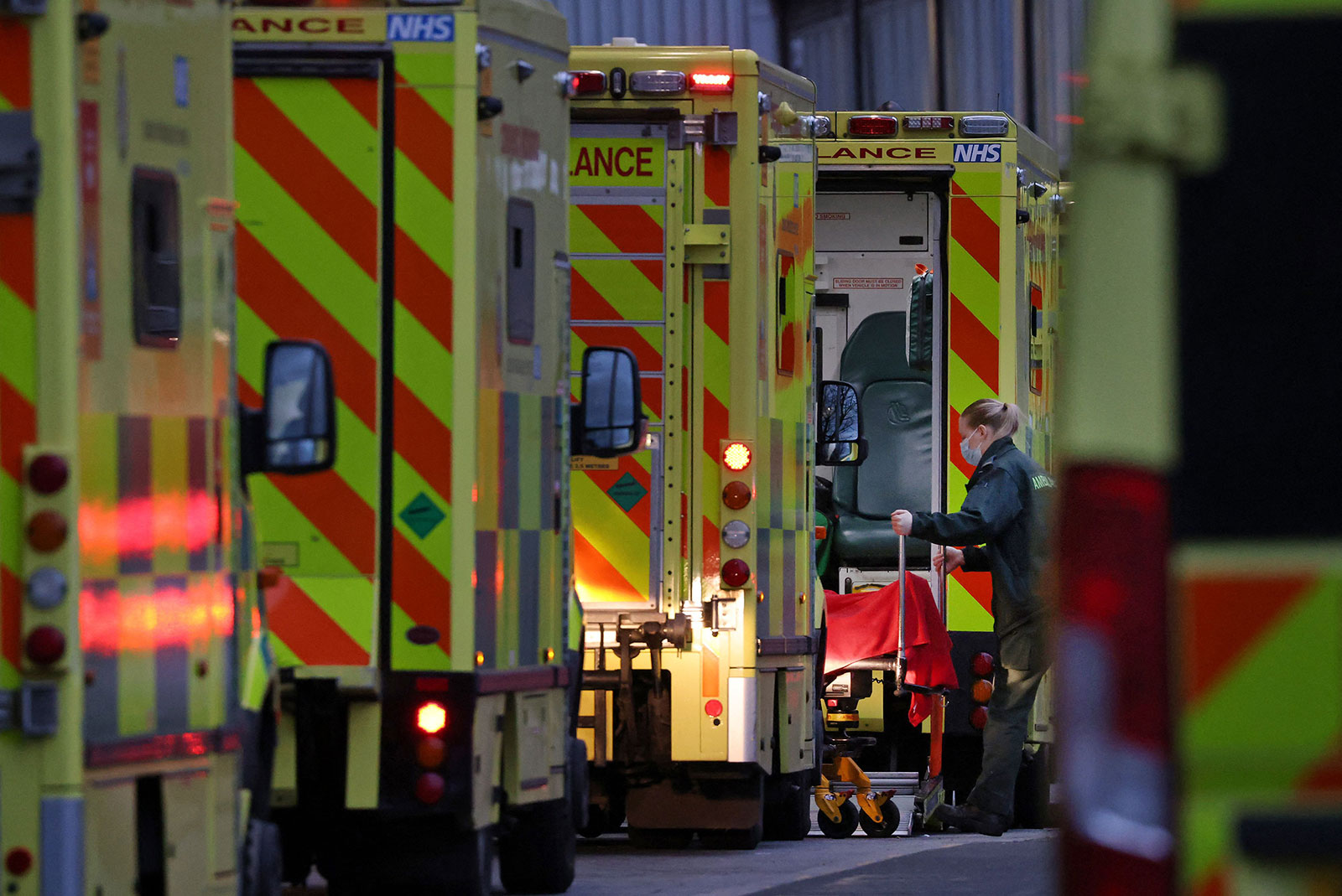 A paramedic unloads a patient from an ambulance outside the Royal London hospital in London on December 28.