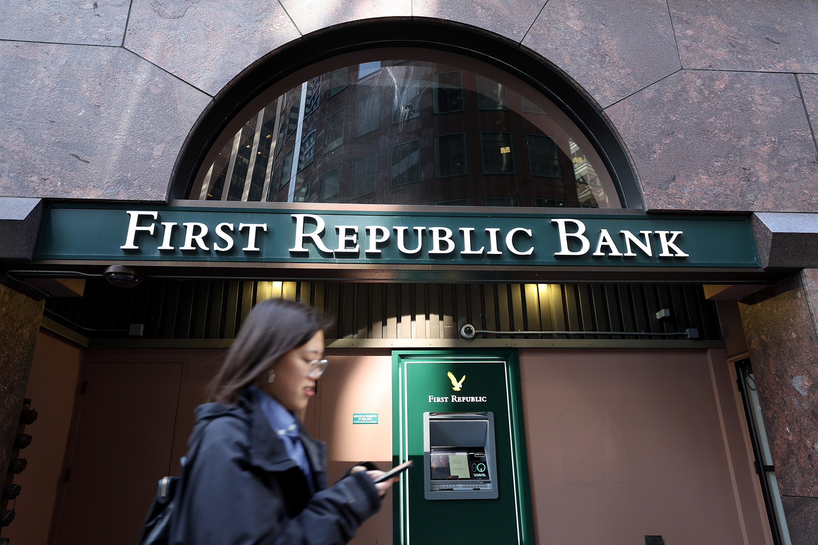 A pedestrian walks by a First Republic Bank office on March 16 in San Francisco, California.