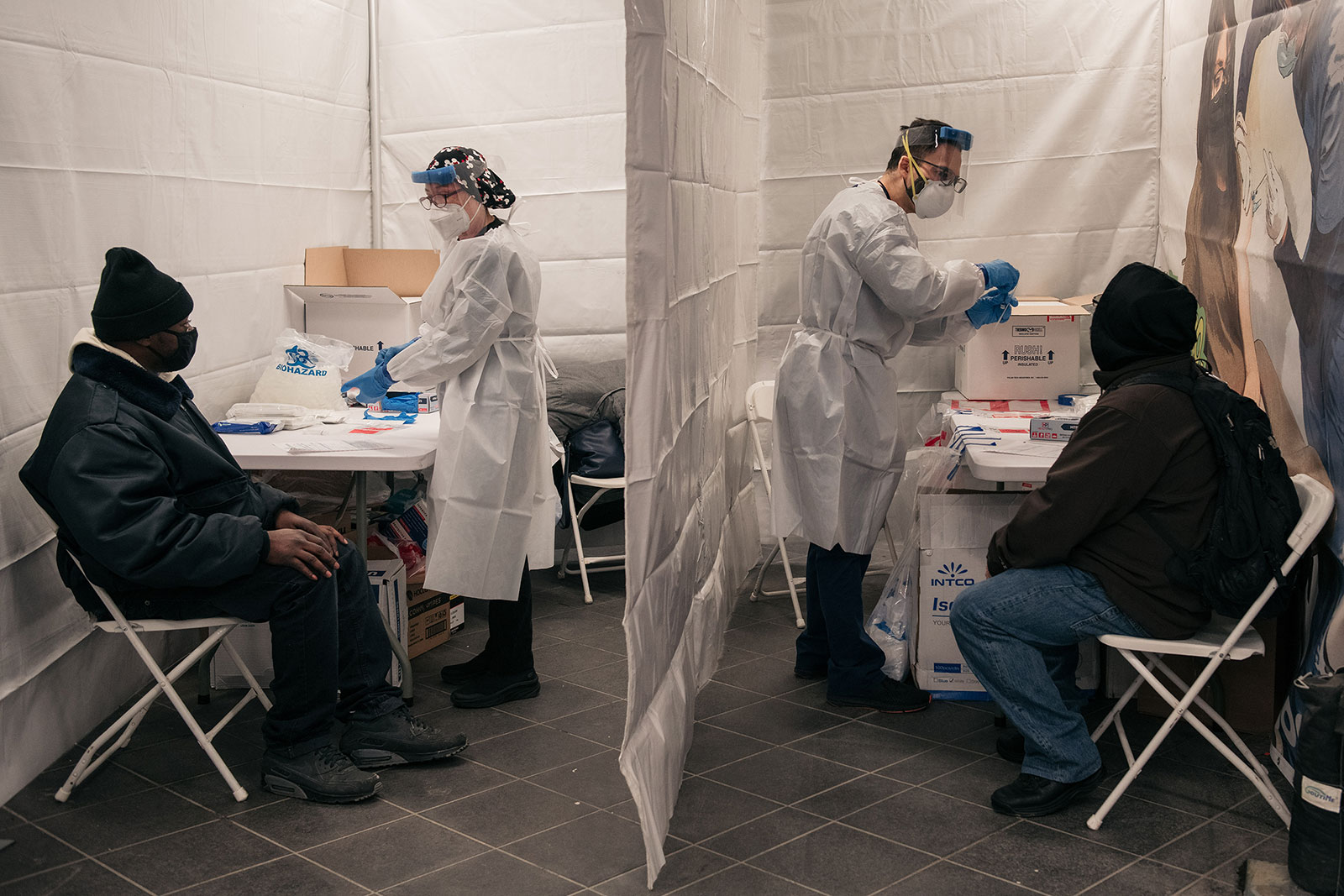 Medical workers administer Covid-19 tests at a subway station in New York on December 27.
