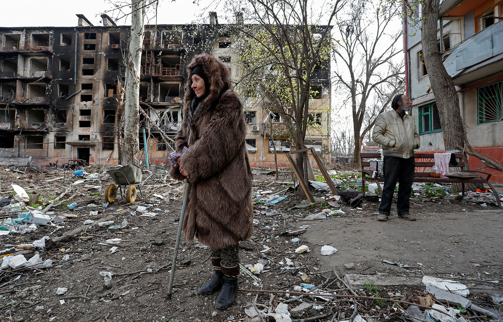 Local residents stand in a courtyard near a destroyed residential building in Mariupol, Ukraine, on Sunday, April 17. 