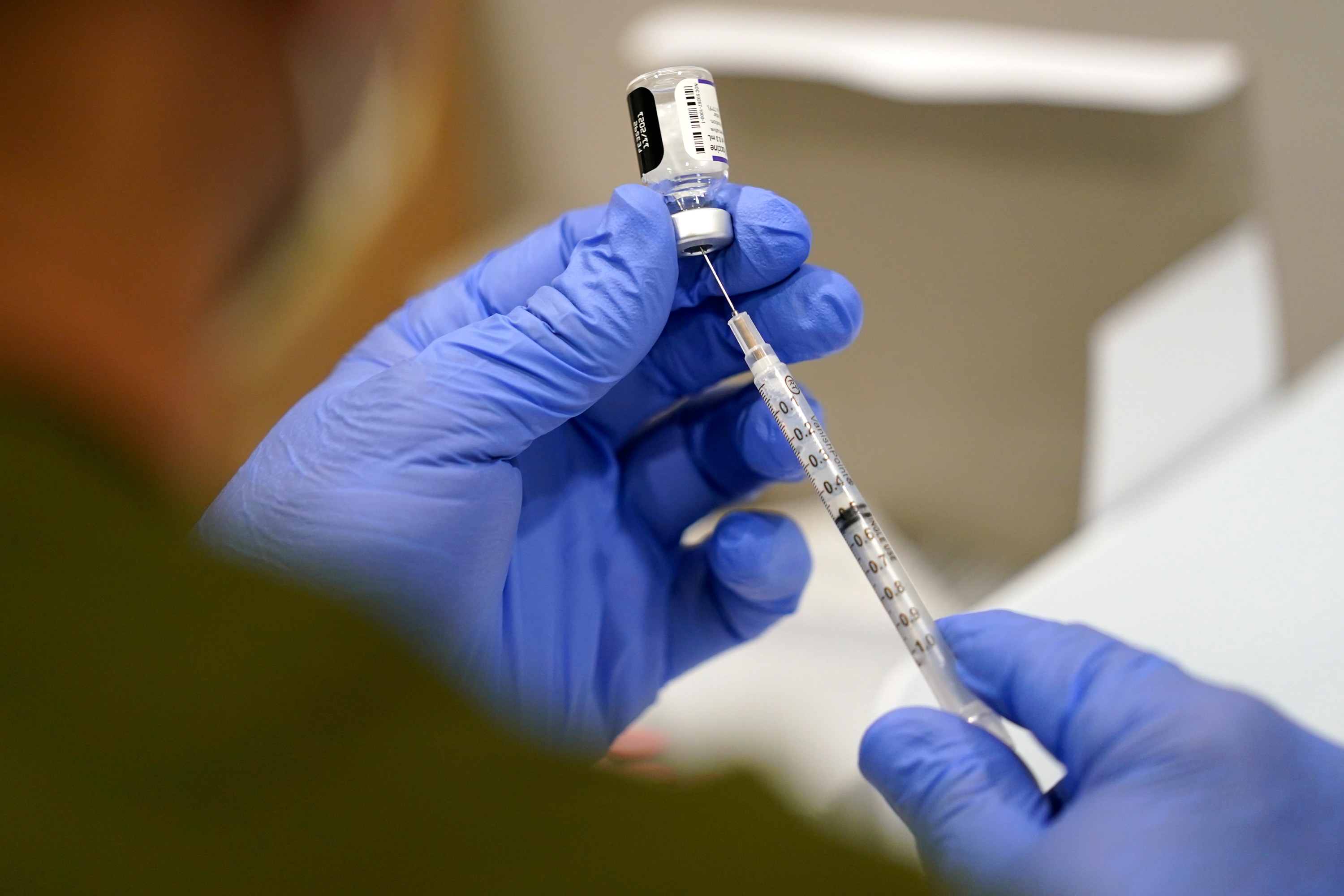 A healthcare worker fills a syringe with the Pfizer COVID-19 vaccine at Jackson Memorial Hospital on October 5, in Miami.  