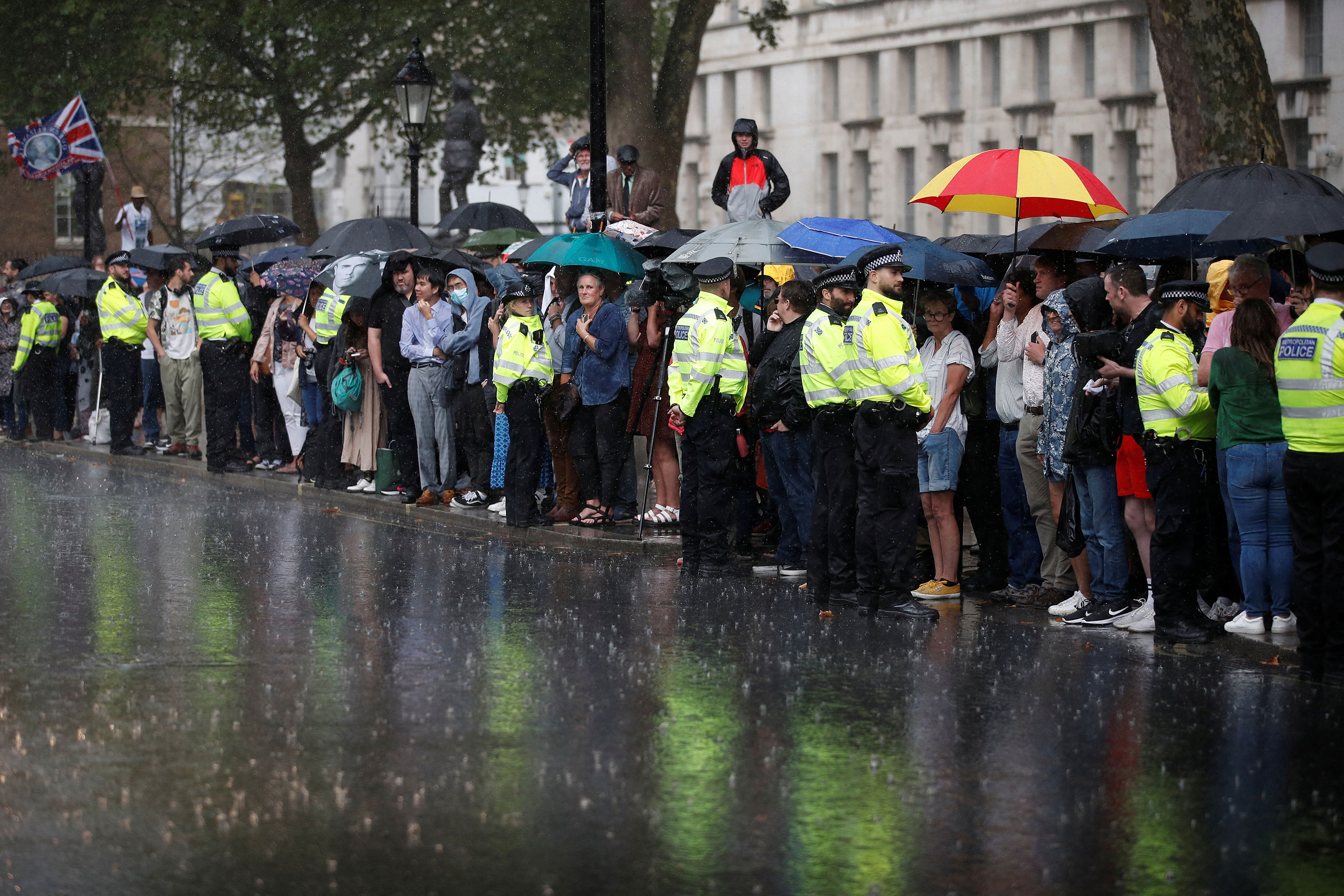 People wait amid heavy rainfall for the arrival of Truss.