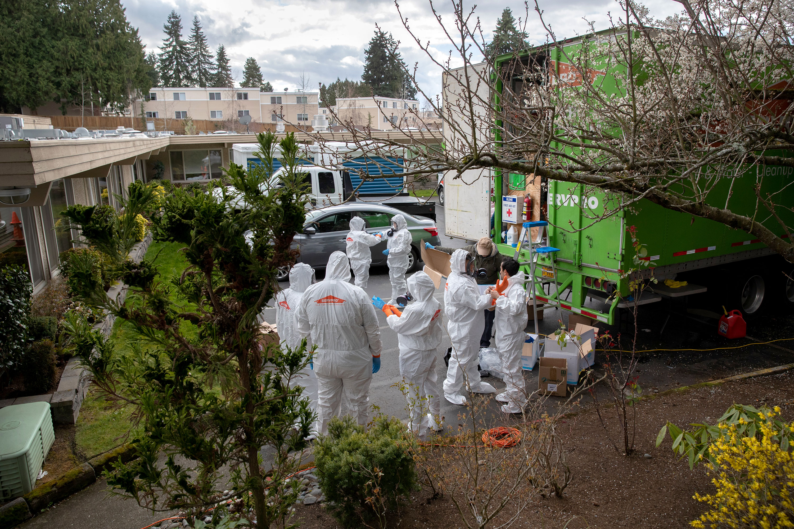 A cleaning crew prepares to enter the Life Care Center in Kirkland, Washington on March 12.