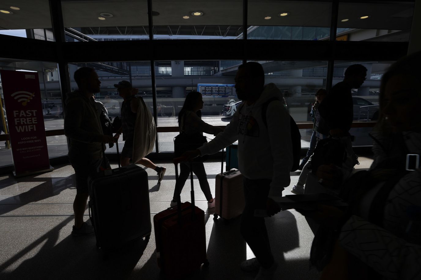 Travelers pass through San Francisco International Airport on Monday, November 21.