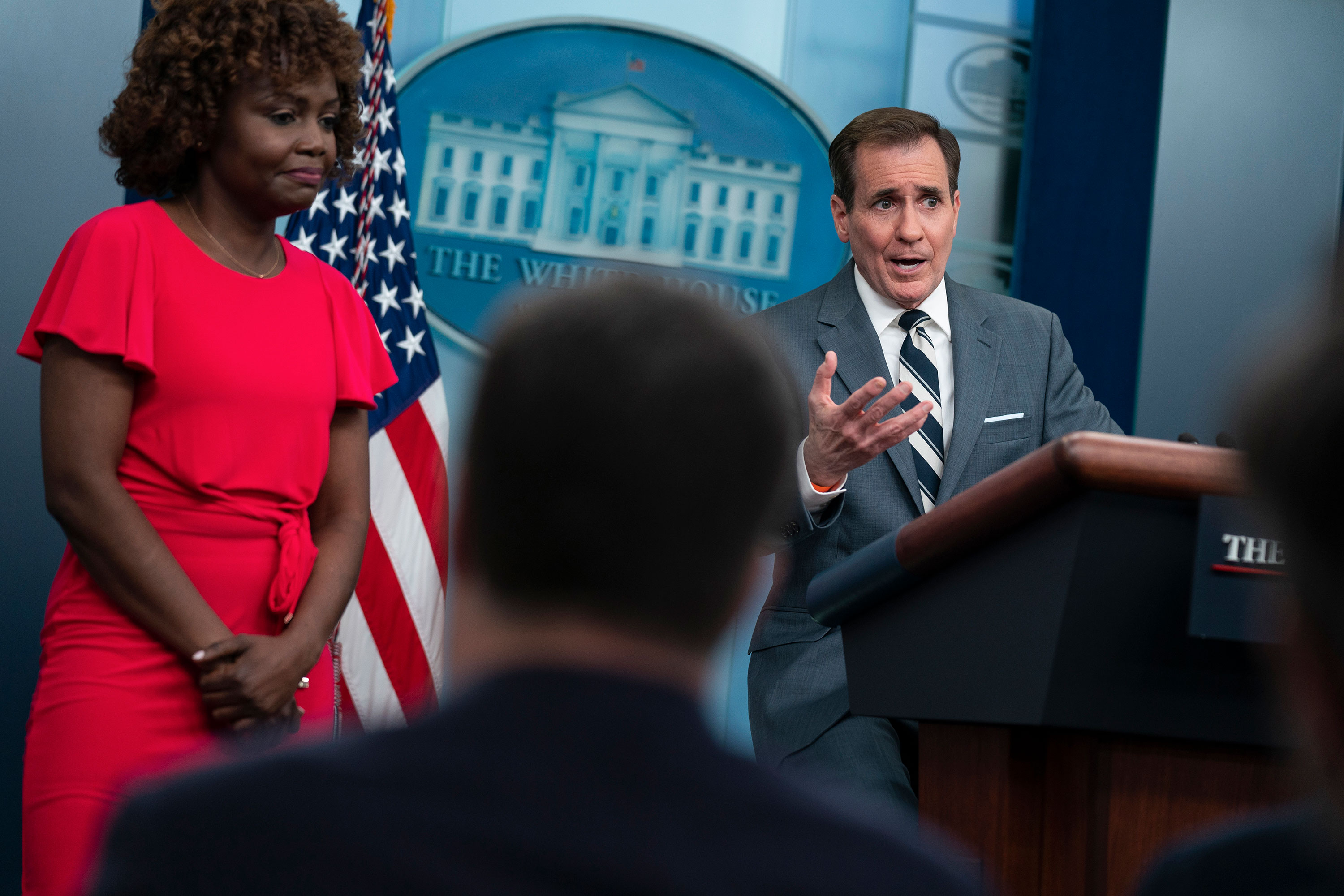 White House press secretary Karine Jean-Pierre listens as National Security Council spokesman John Kirby speaks during a press briefing at the White House on Thursday.