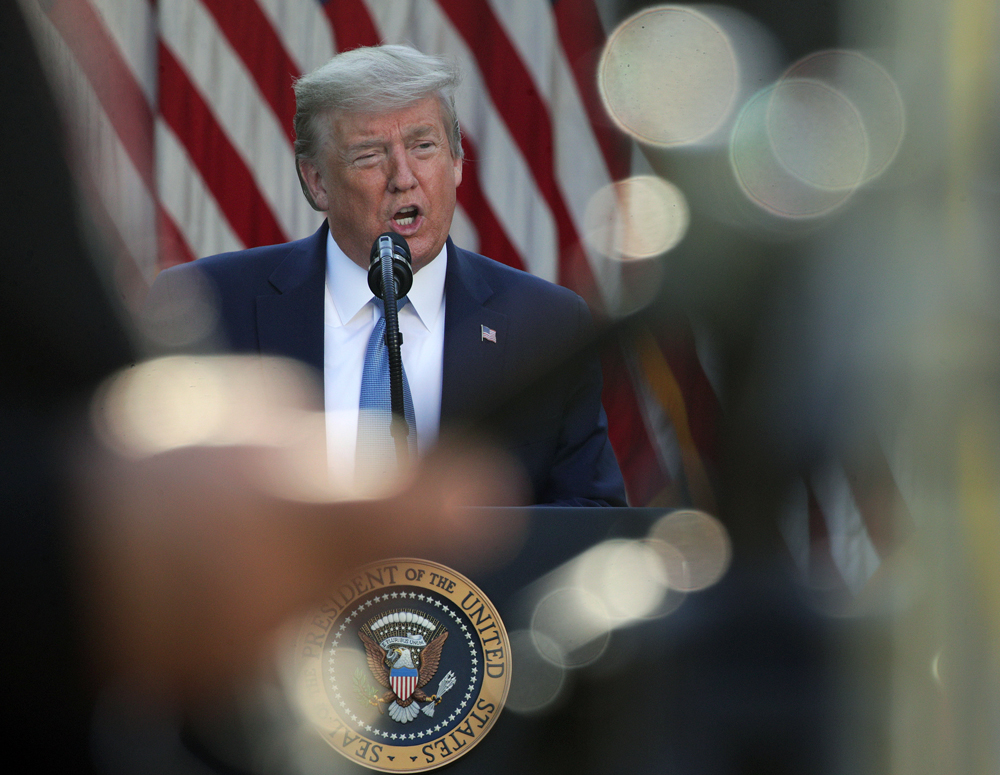 US President Donald Trump speaks at the daily briefing of the White House Coronavirus Task Force in the Rose Garden at the White House on Wednesday, April 15 in Washington.