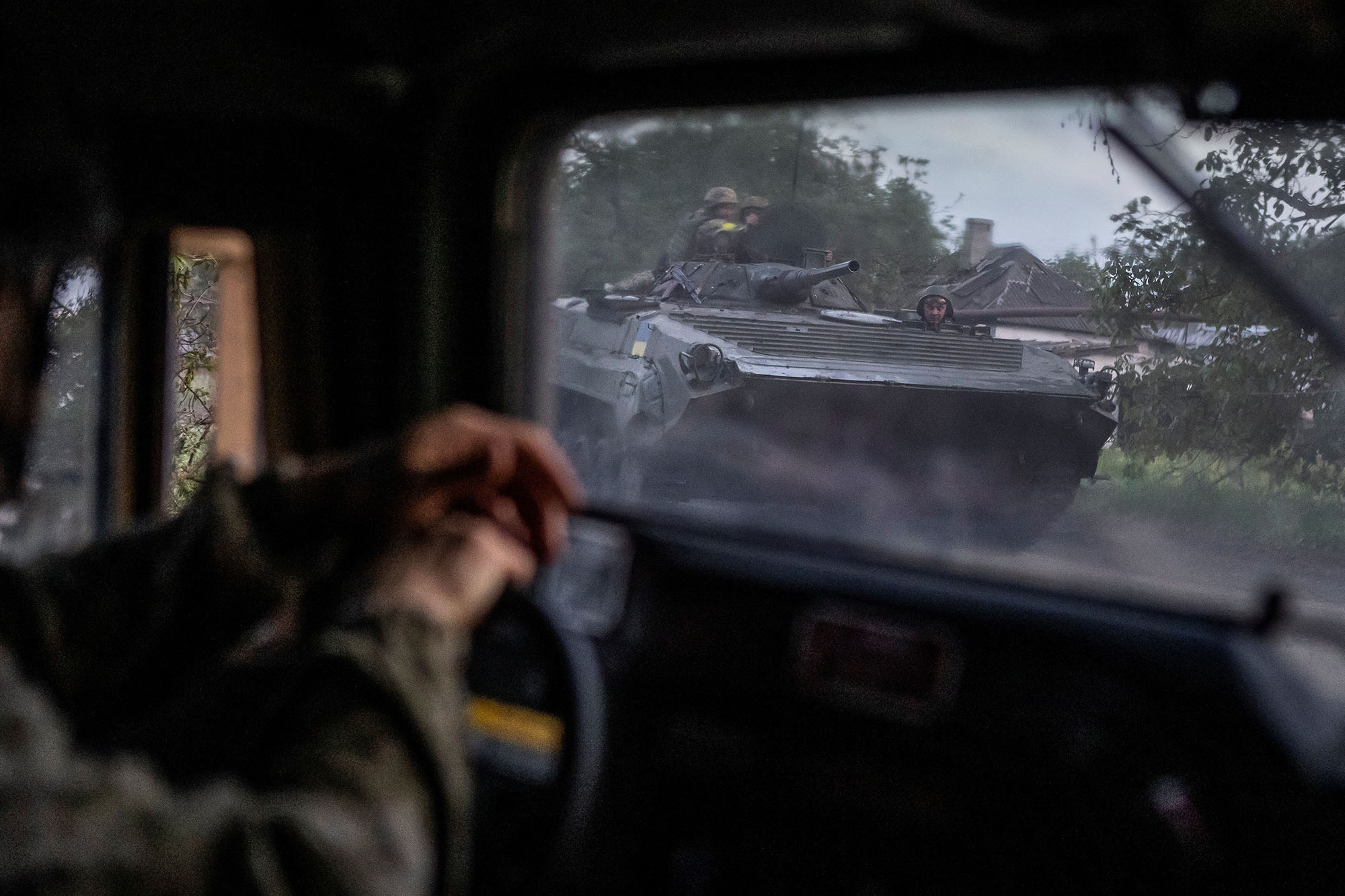 Ukrainian service members ride atop of a BMP-1 infantry fighting vehicle near the frontline town of Bakhmut in Donetsk region, Ukraine, on May 23.
