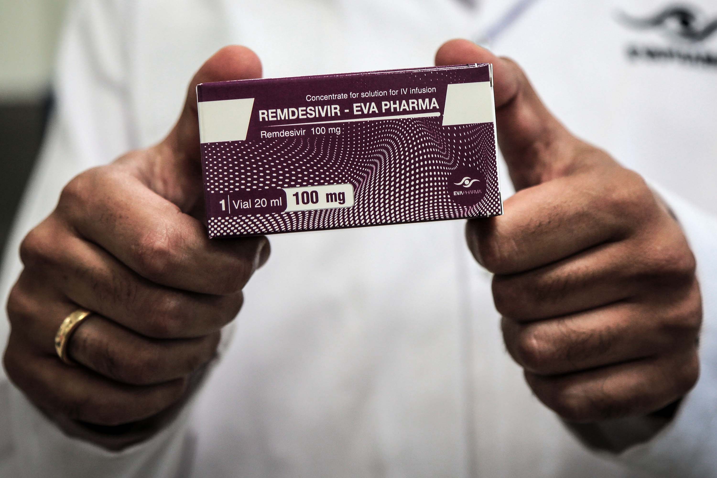 An employee of the Egyptian pharmaceutical company Eva Pharma holds a pack of the antiviral medication remdesivir at the company's factory in Giza, Egypt, in June 2020.