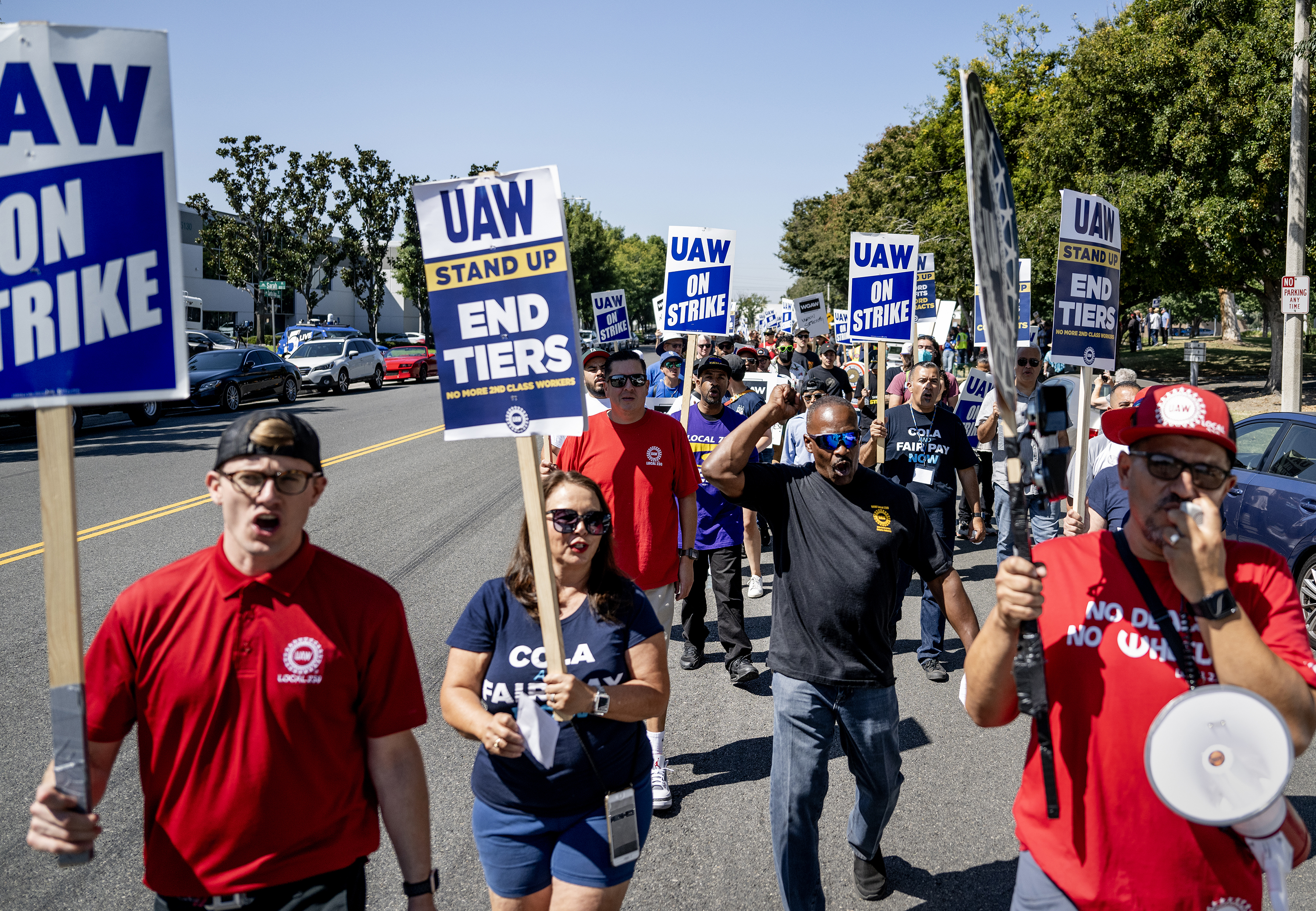 Striking United Auto Workers (UAW) march in front of the Stellantis Mopar facility on September 26, in Ontario, California.