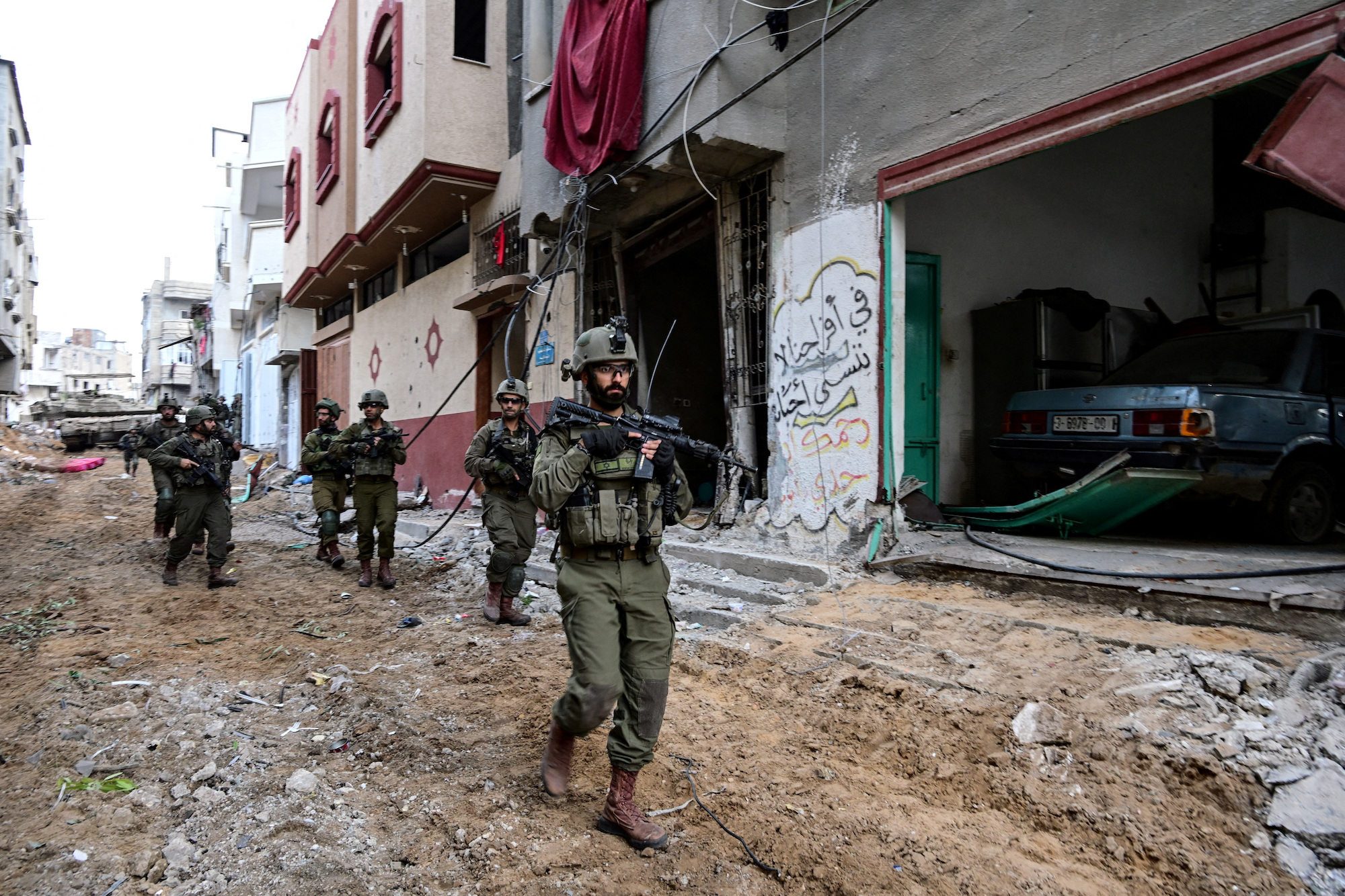 Israeli soldiers operate at the Shajaiya district of Gaza city on December 8.