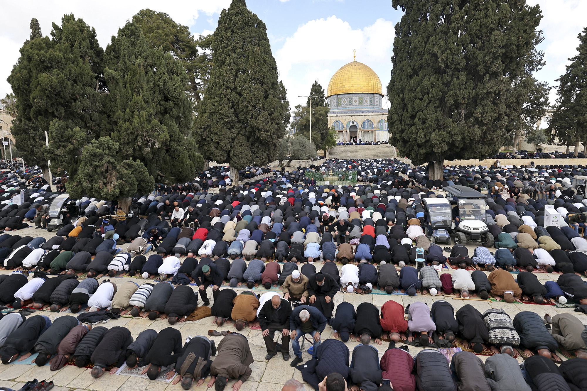 Muslim devotees offer first Friday noon prayers of the Islamic holy fasting month of Ramadan against the backdrop of the Dome of the Rock at the compound of the Al-Aqsa mosque in the Old City of Jerusalem on March 15.