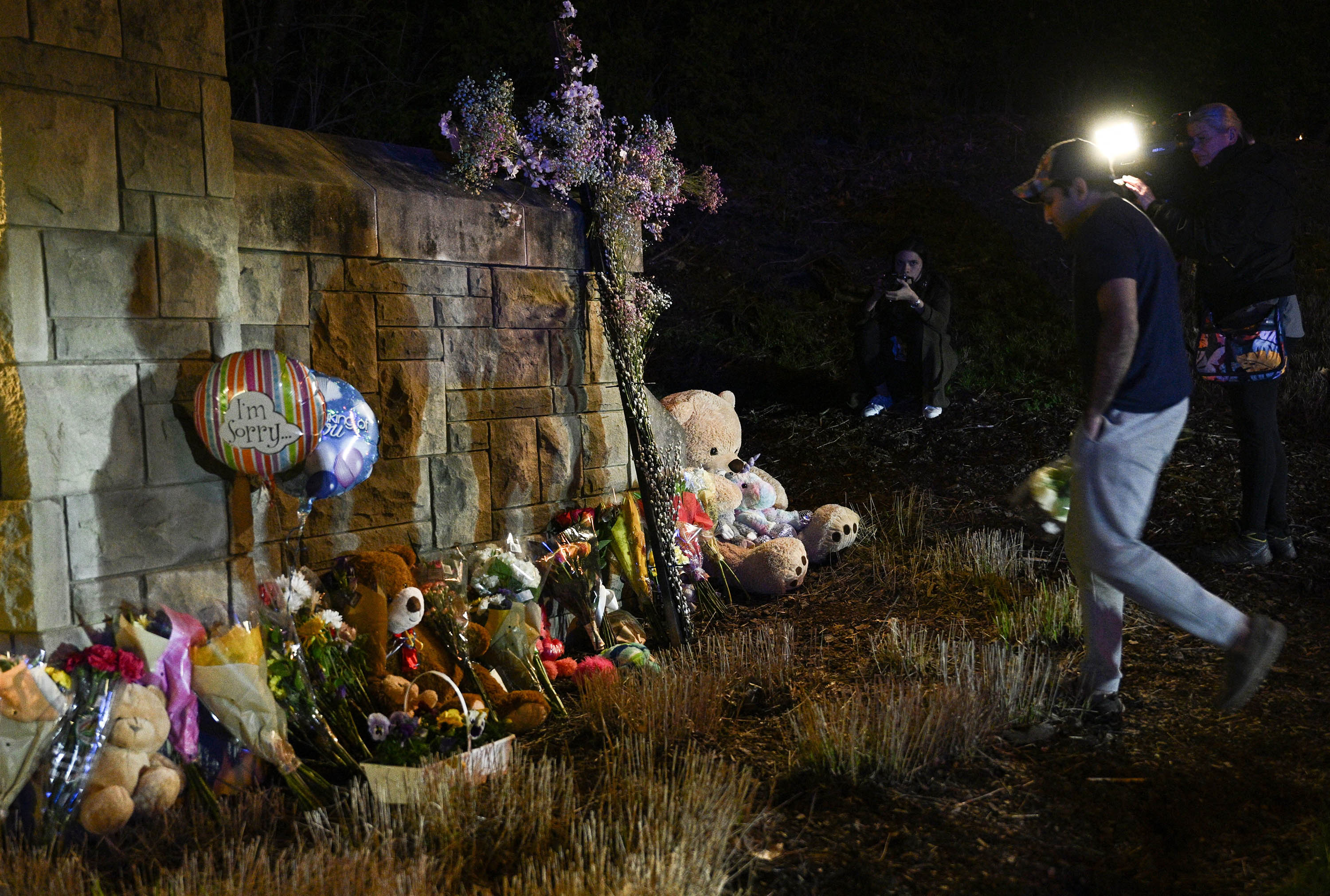 A person places flowers at a makeshift memorial outside the Covenant School in Nashville, Tennessee, on March 27. 