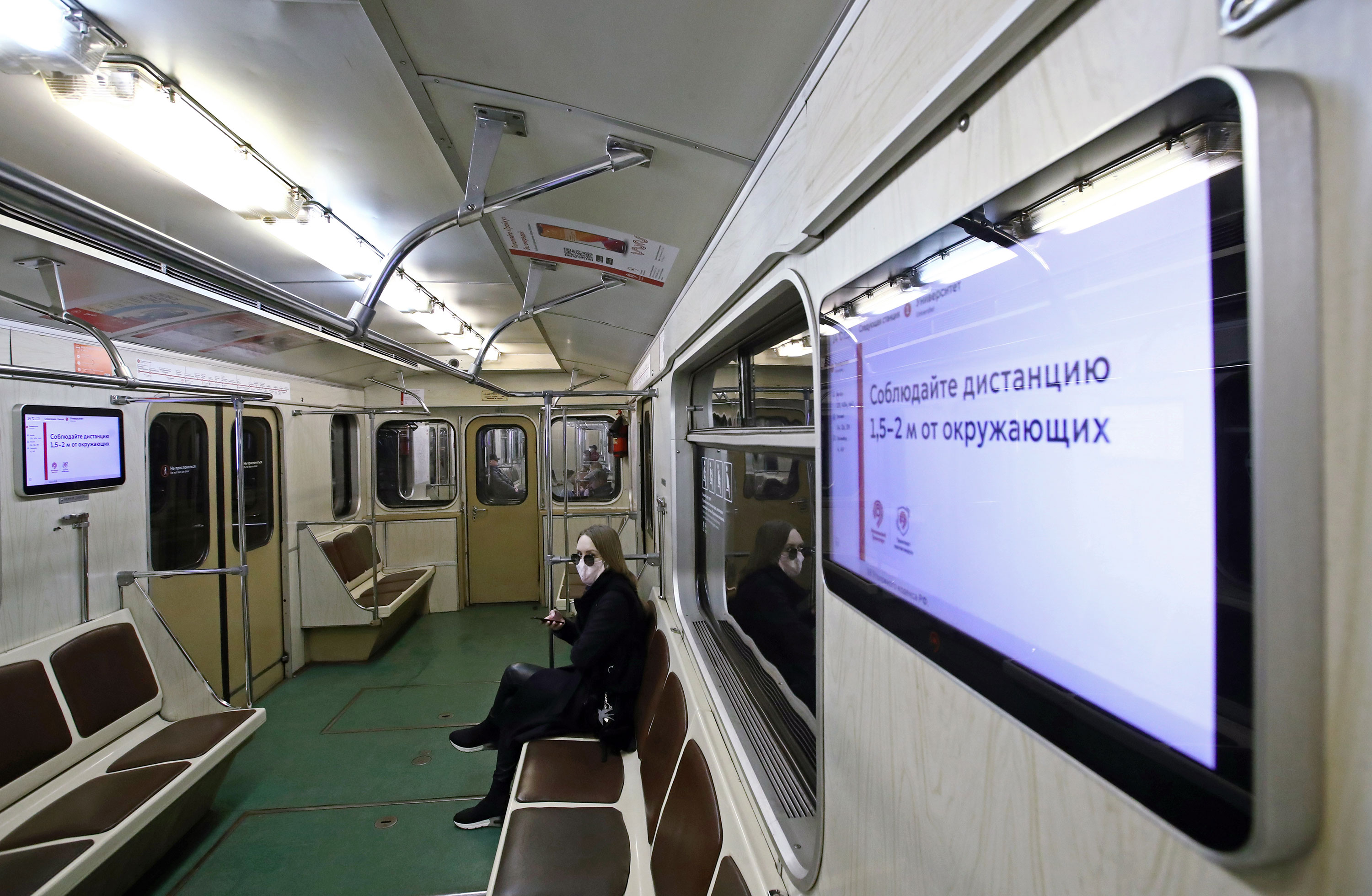 An announcement on a screen urges people to keep 1.5-2m apart in a subway car in Moscow on March 29.