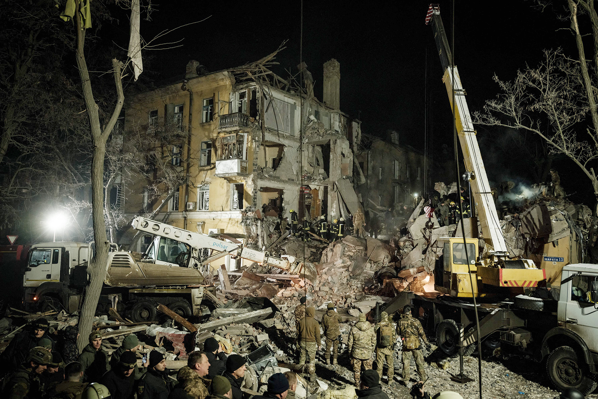 Rescuers remove debris to search for survivors at a destroyed apartment building hit by a rocket in downtown Kramatorsk, Ukraine, on February 1.